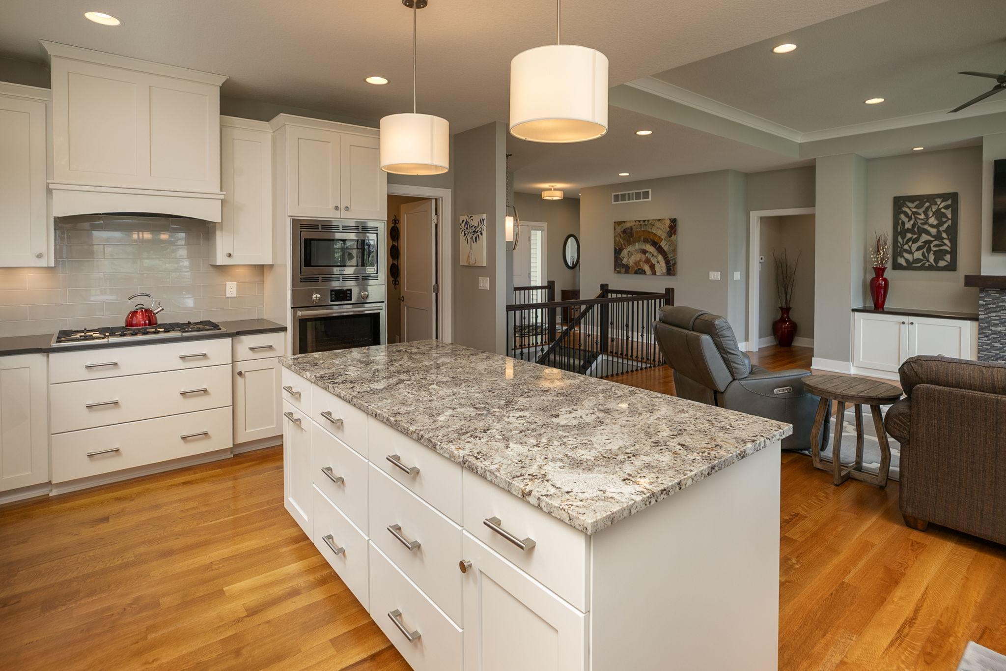 Drum shades above the island illuminate the area