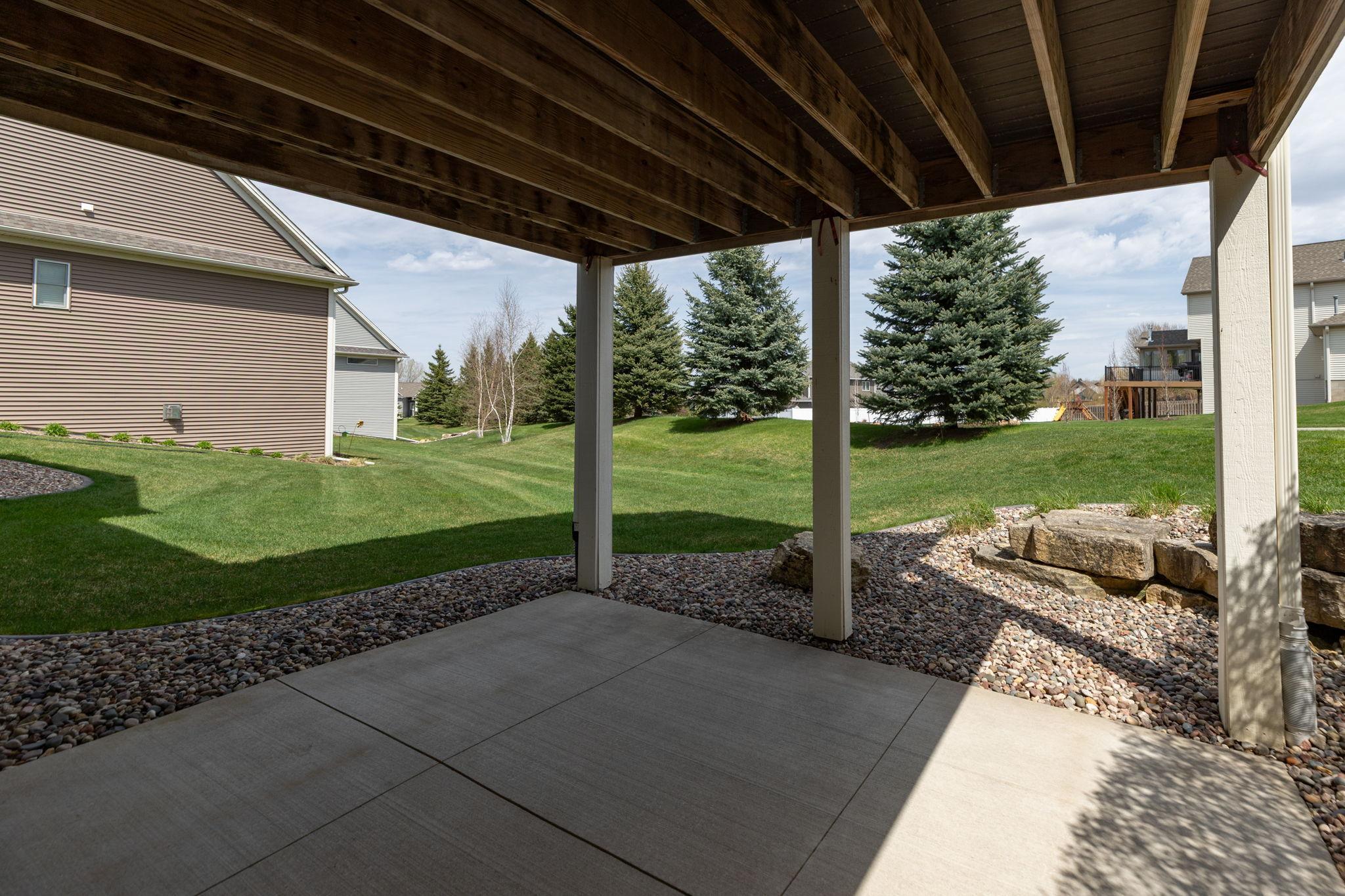 Covered patio and appealing landscape design