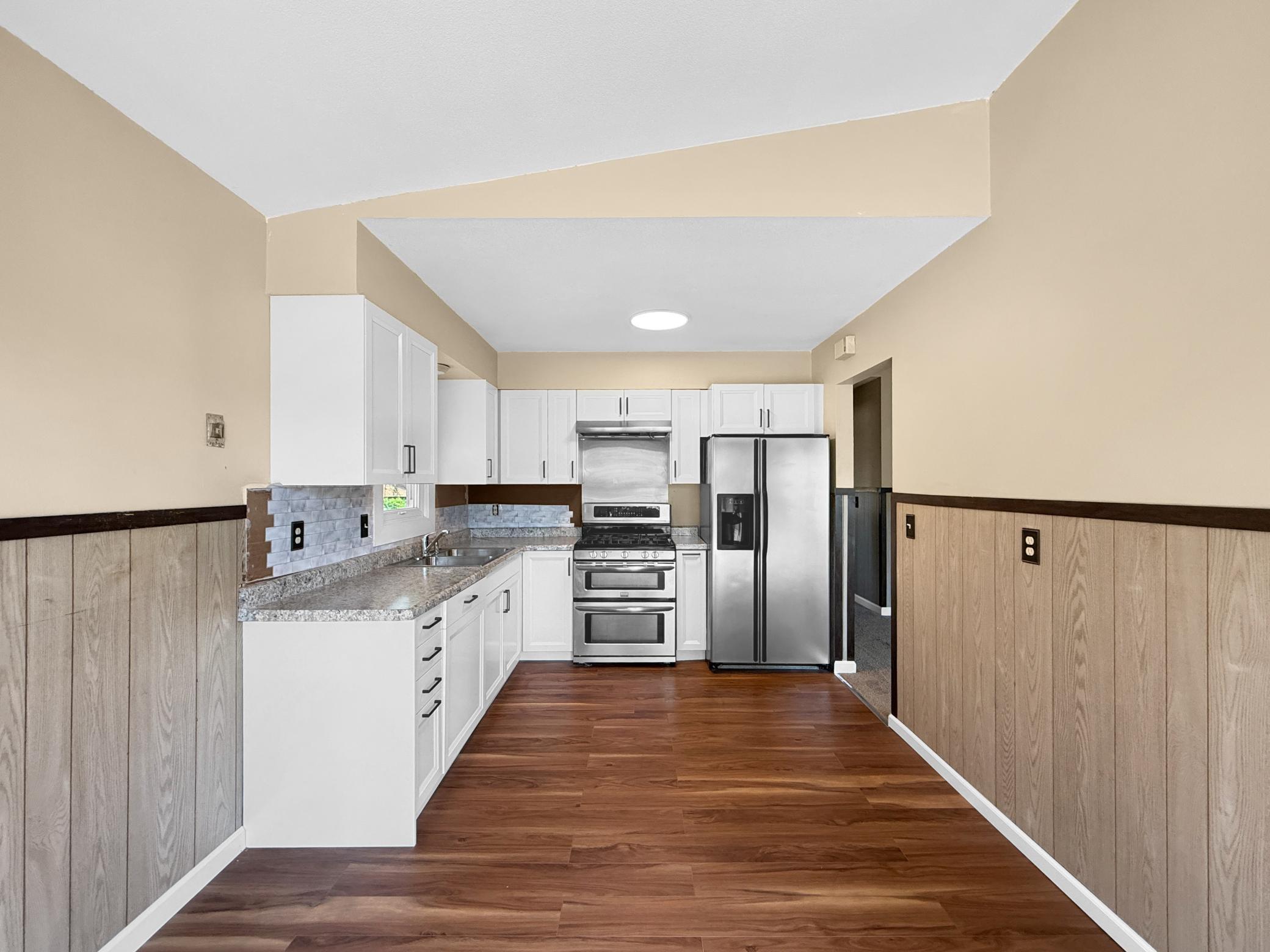 New, white kitchen cabinets and flooring