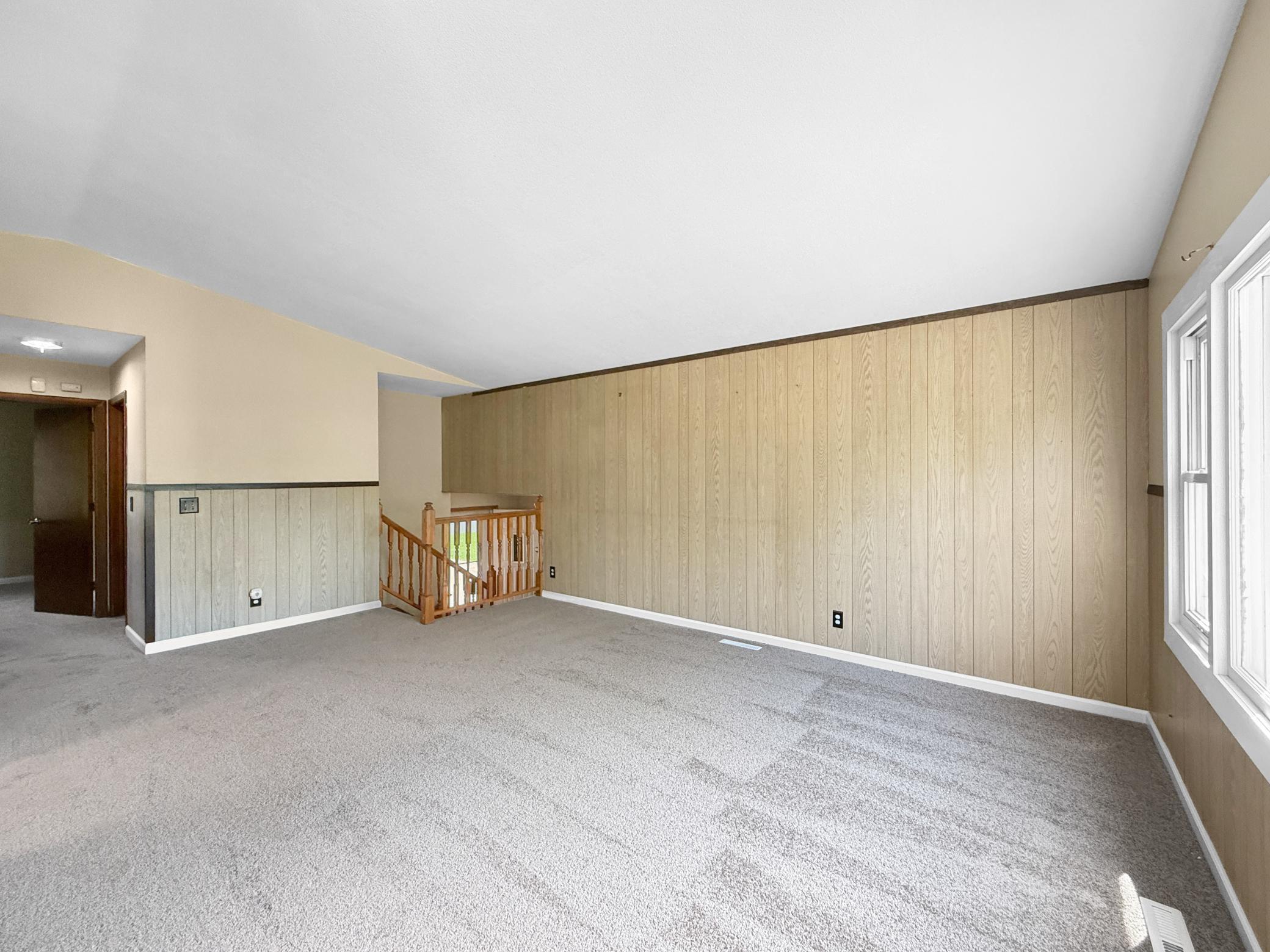 Living room with vaulted ceilings and brand new carpeting