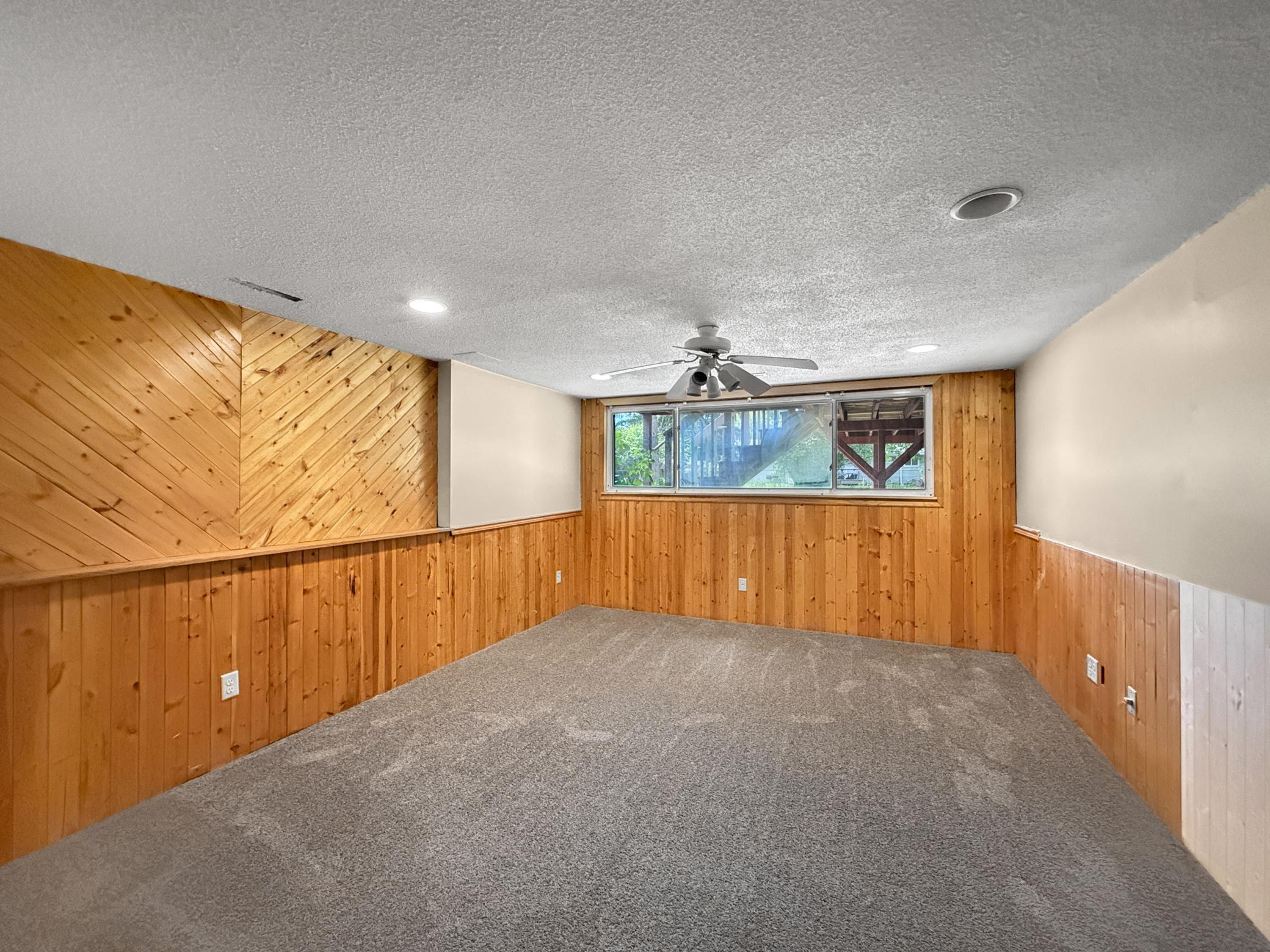 Spacious lower level family room with brand new carpeting