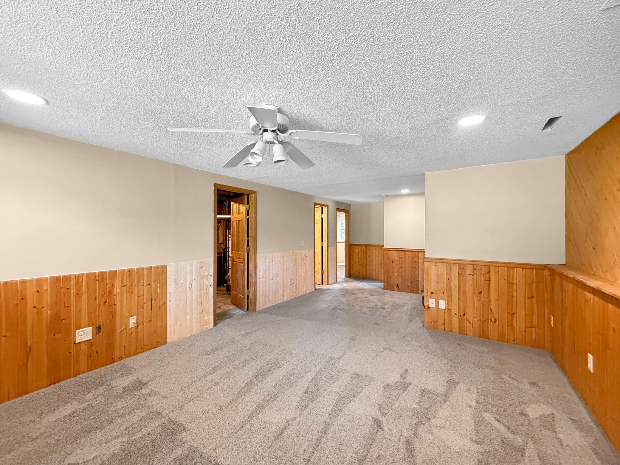 Spacious lower level family room with brand new carpeting