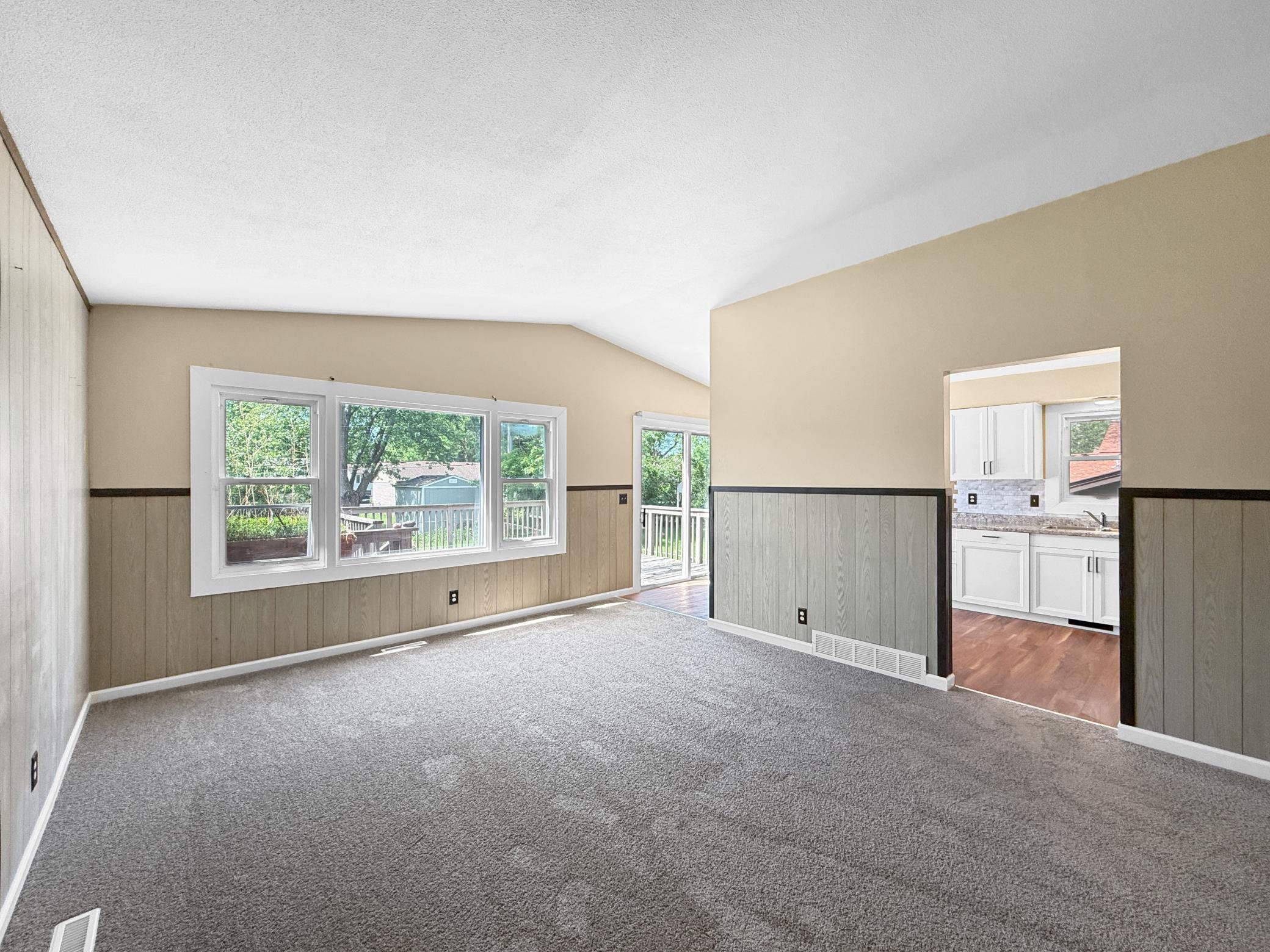 Living room with vaulted ceilings and brand new carpeting