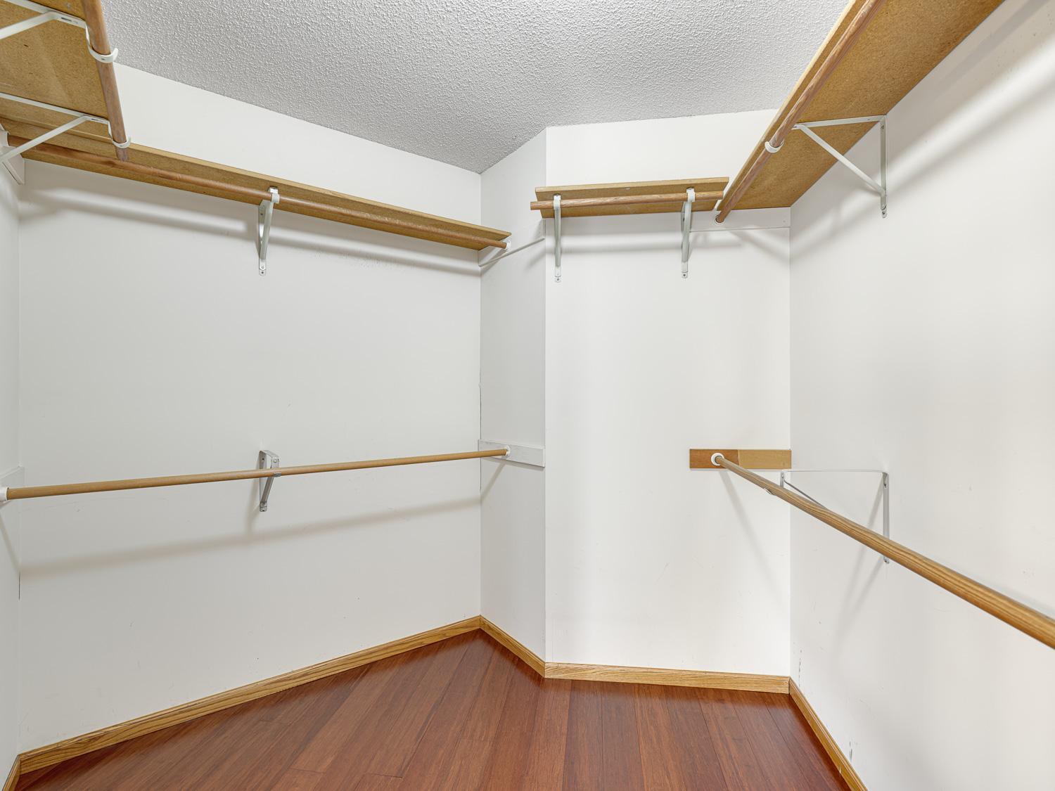 A large walk-in closet keeps everything organized with plenty of space for clothes and accessories.