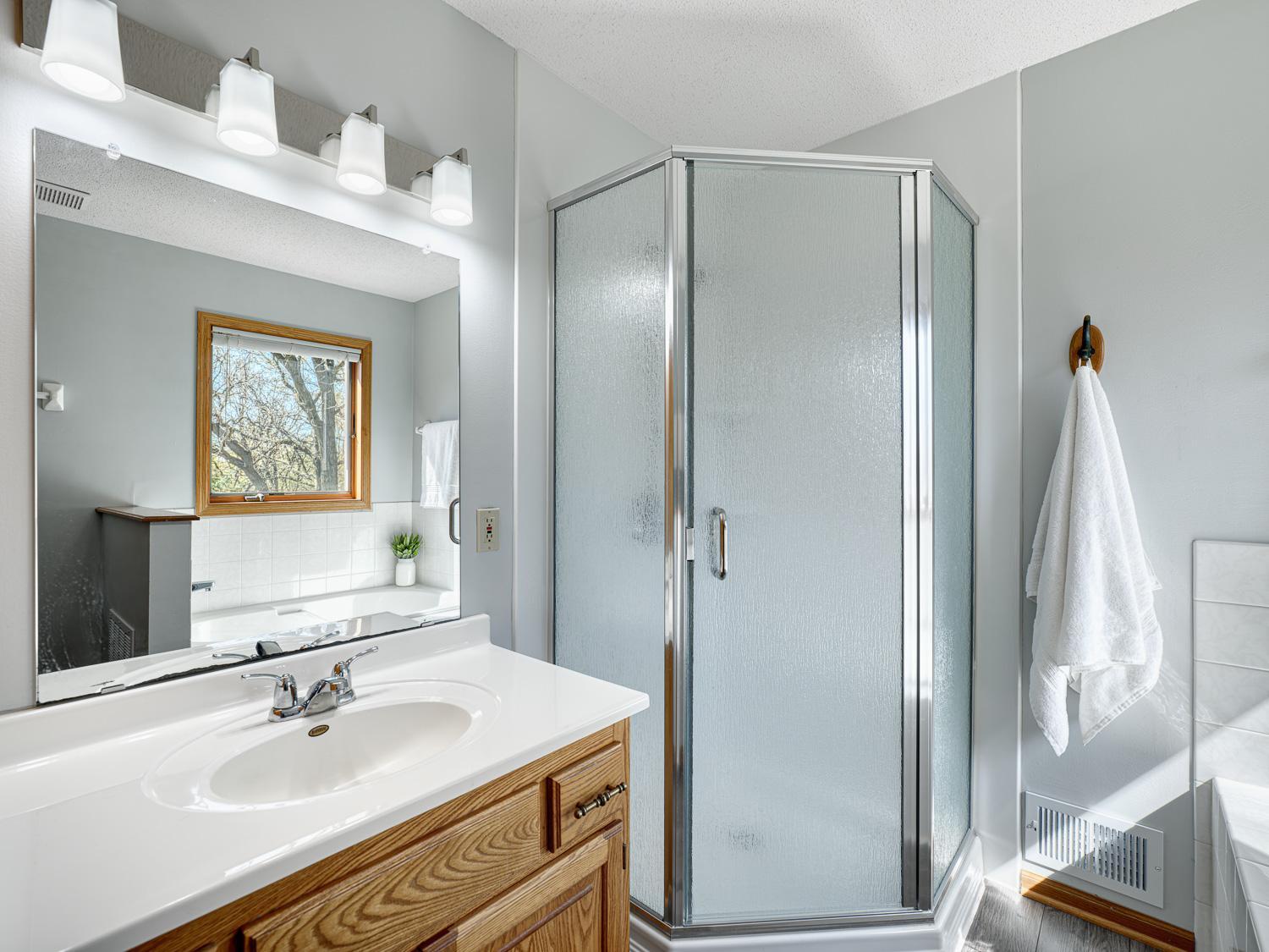 The primary bedroom also features a private full ensuite with a separate tub and shower.