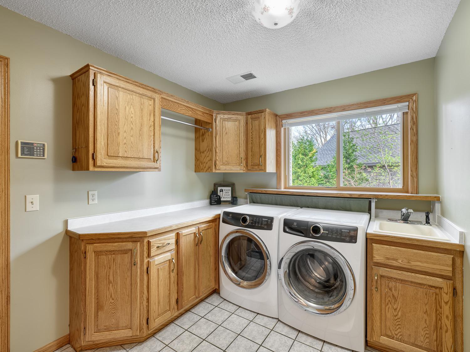Main level laundry room with storage solutions for all your everyday essentials. It has a built in ironing board too.