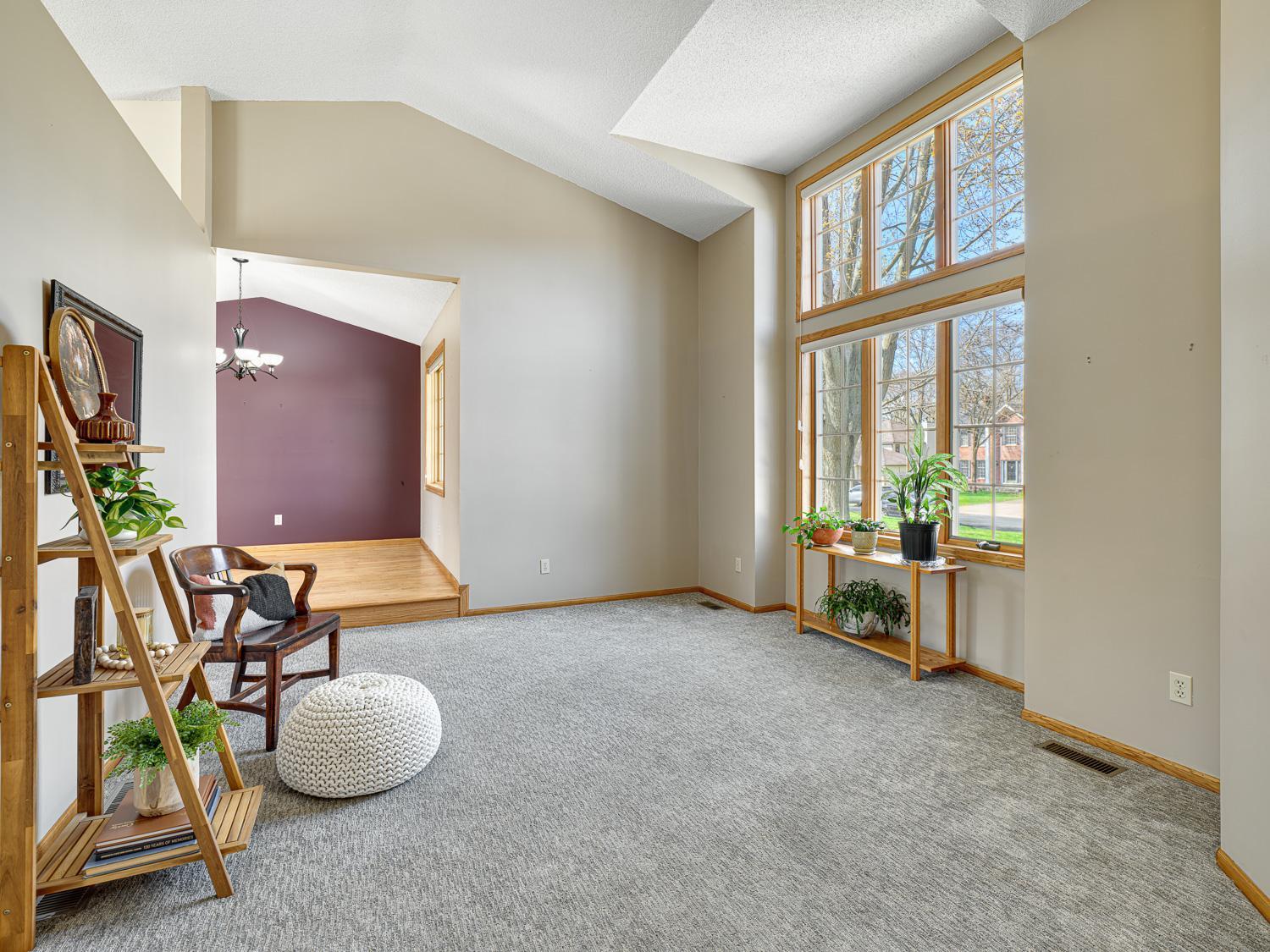 The living room features 1.5 story Andersen windowa that fill the main level with abundant natural light.