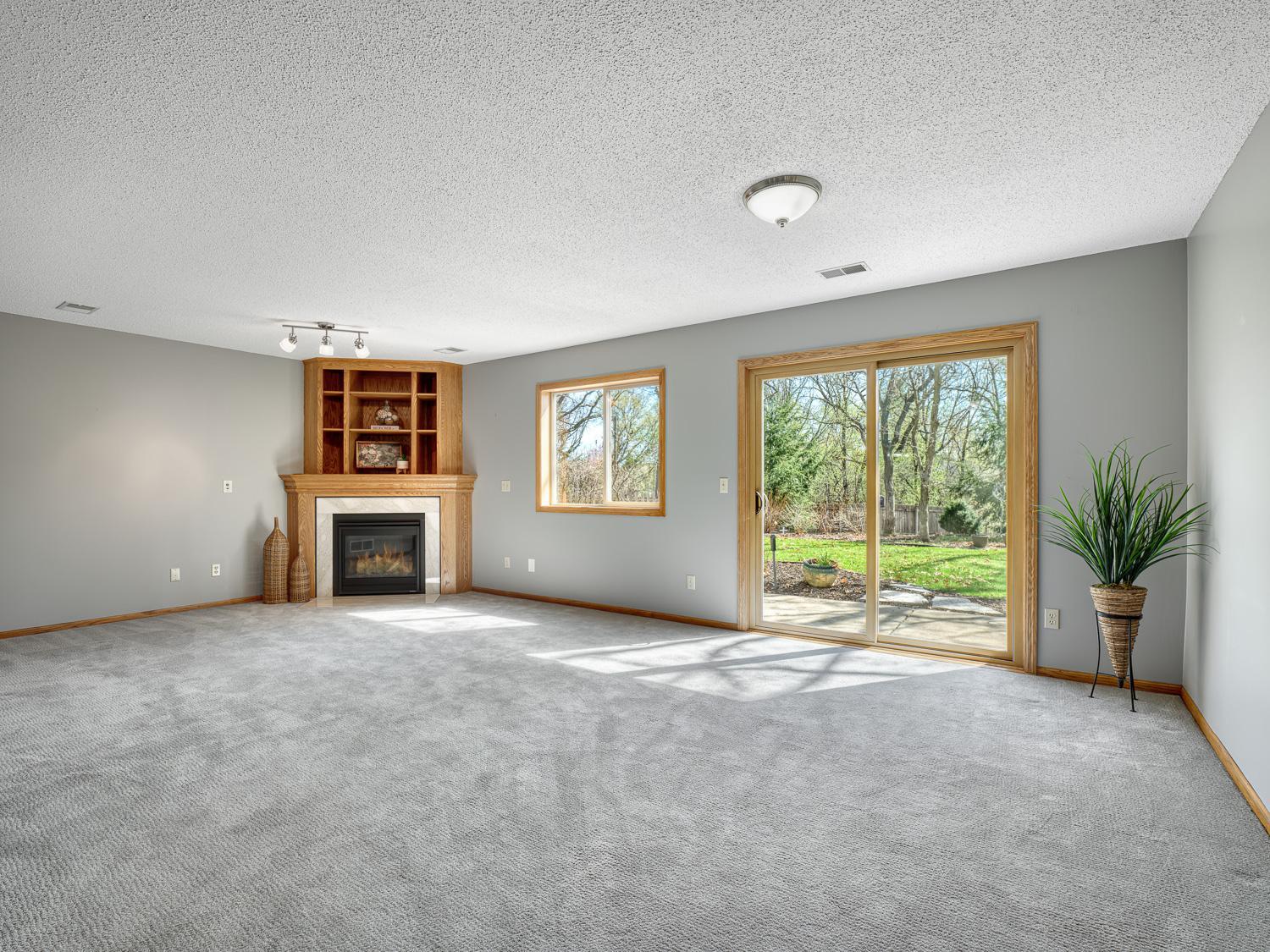 The family room is centered around a cozy gas fireplace and offers easy access to the patio and backyard.