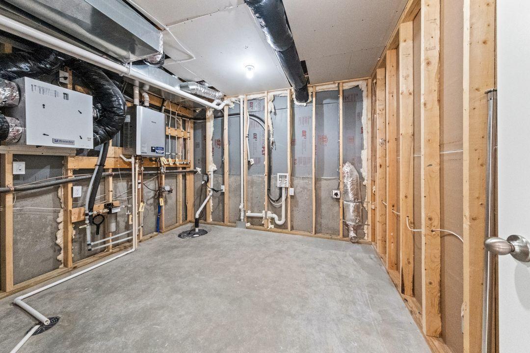 Mechanical room shared with laundry.