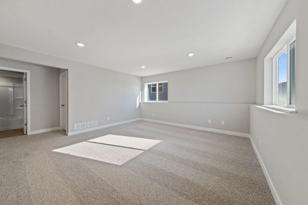 Spacious, lower level family room. Actual home will include 6ft sliding door to access the back yard.