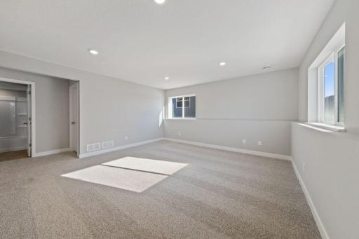 Spacious, lower level family room. Actual home will include 6ft sliding door to access the back yard.