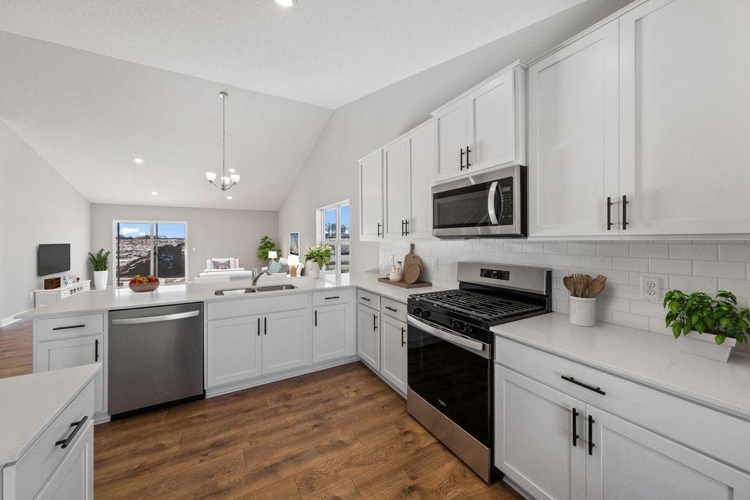 Well appointed kitchen with stainless steel appliances, quartz countertops, tile backsplash and much more!
