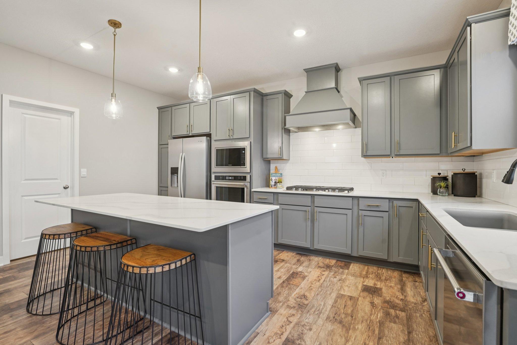 Stunning kitchen with large island. Photo of model home, color and options will vary.