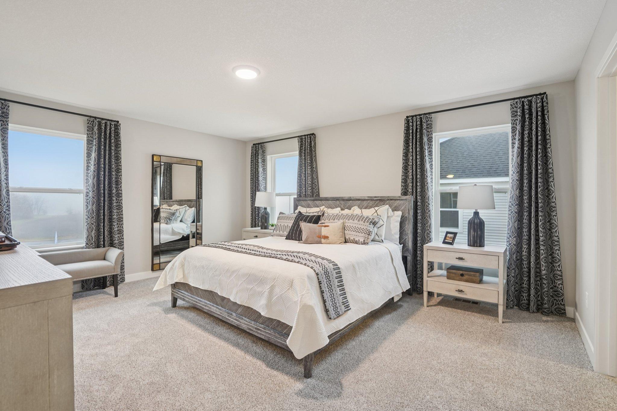 Primary bedroom. Photo of model home, color and options will vary.