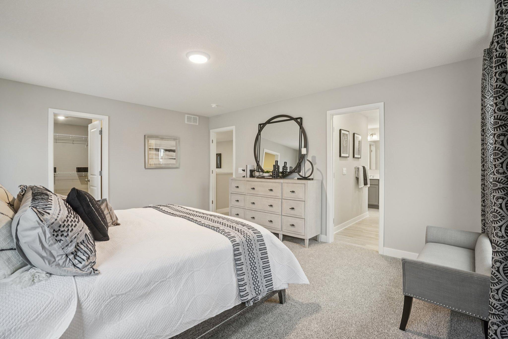 Primary bedroom. Photo of model home, color and options will vary.