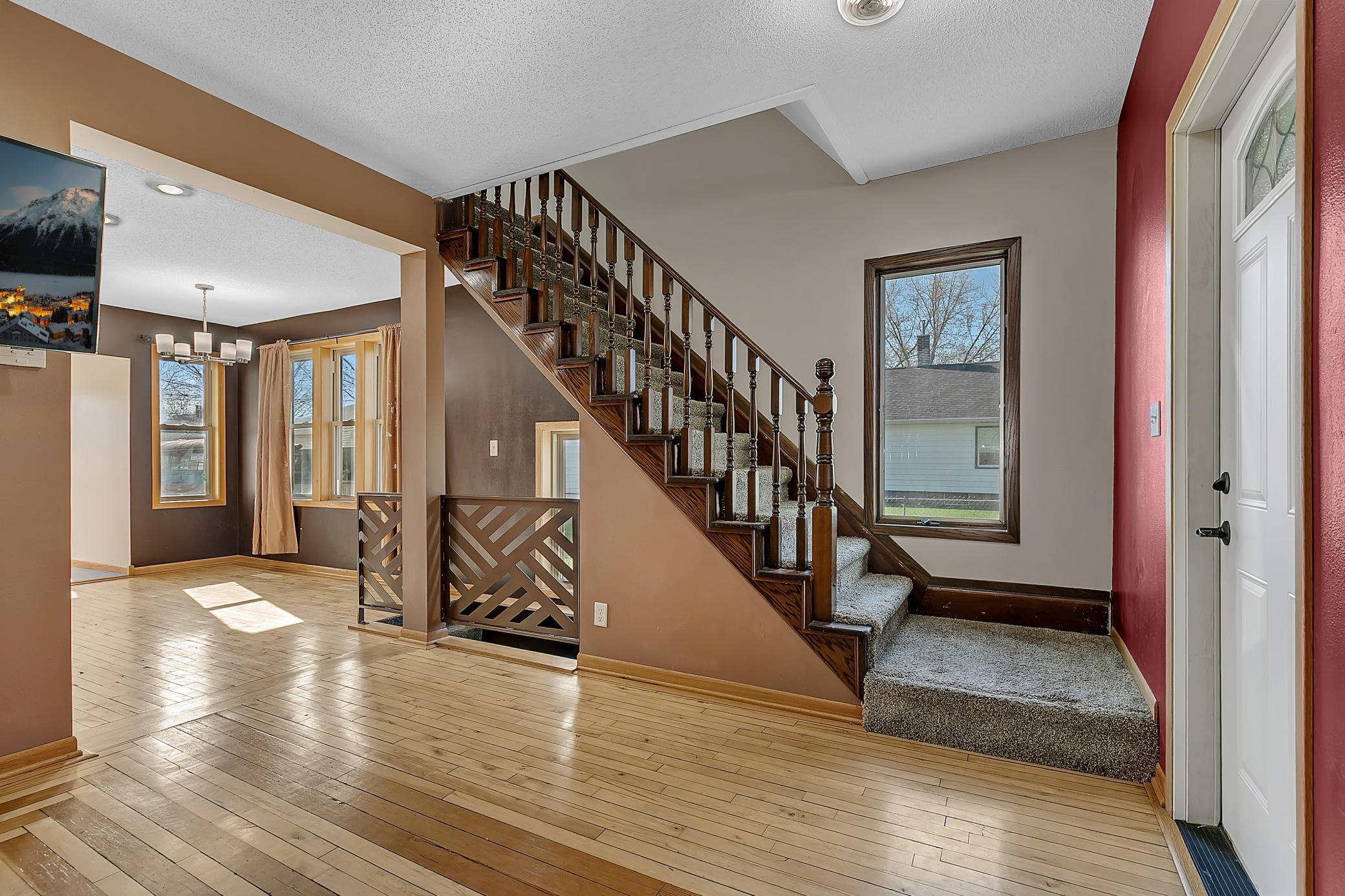 Hardwood floors flow seamlessly through the living room, dining area, and kitchen, creating a cohesive feel.