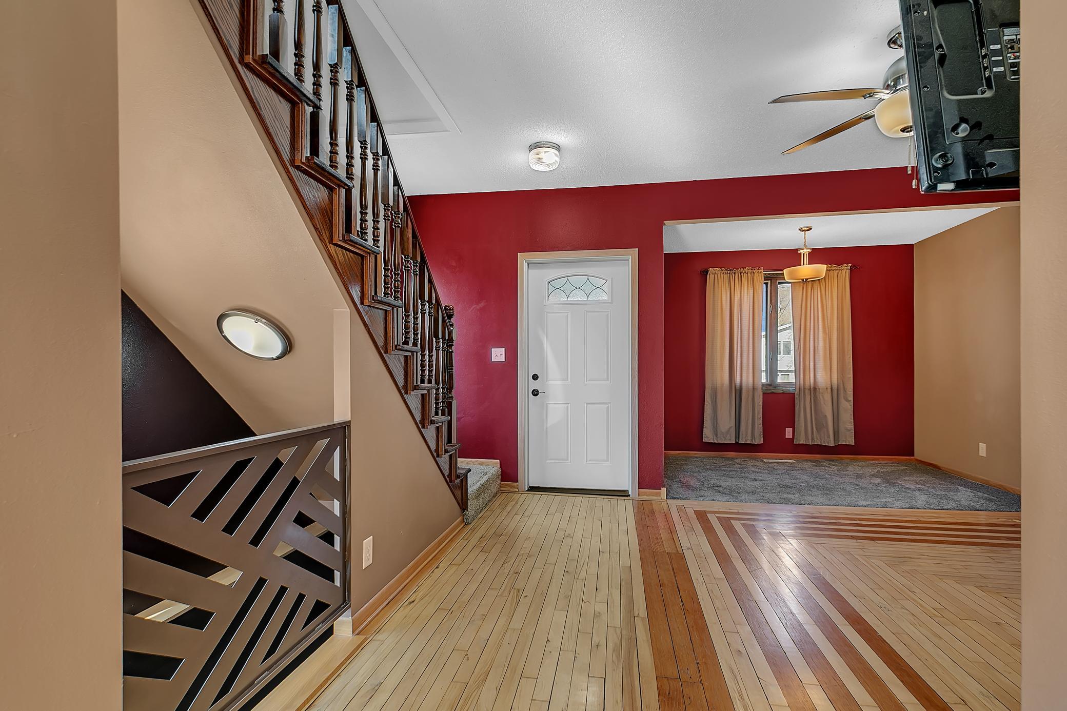 The living room is bright and comfortable, complete with a ceiling fan and updated lighting that adds a modern touch throughout the home.