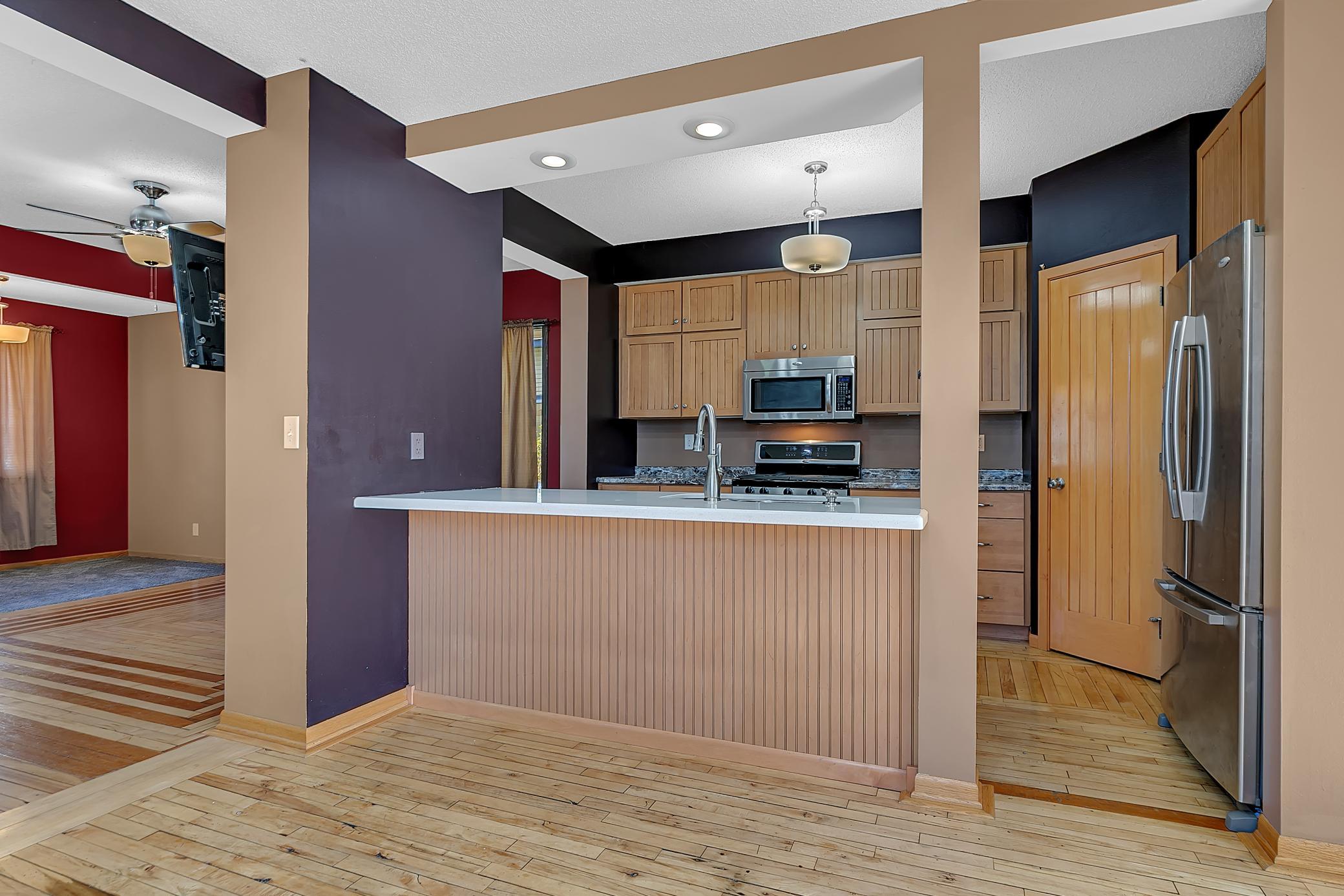 Extra seating space at this kitchen counter allows for setting out quick snacks.