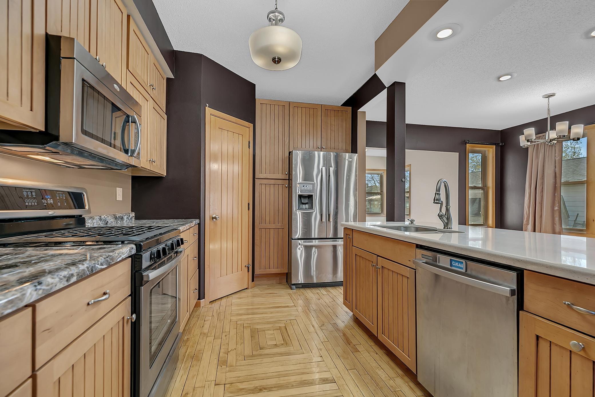 A walk-in pantry with its own light provides ample storage.