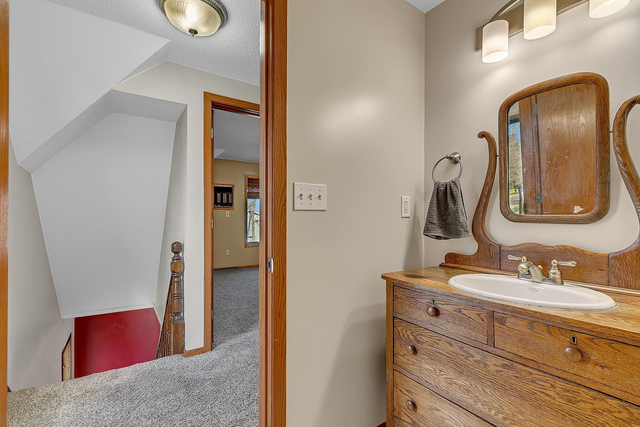 Upper level three-quarter bathroom featuring a custom vanity!
