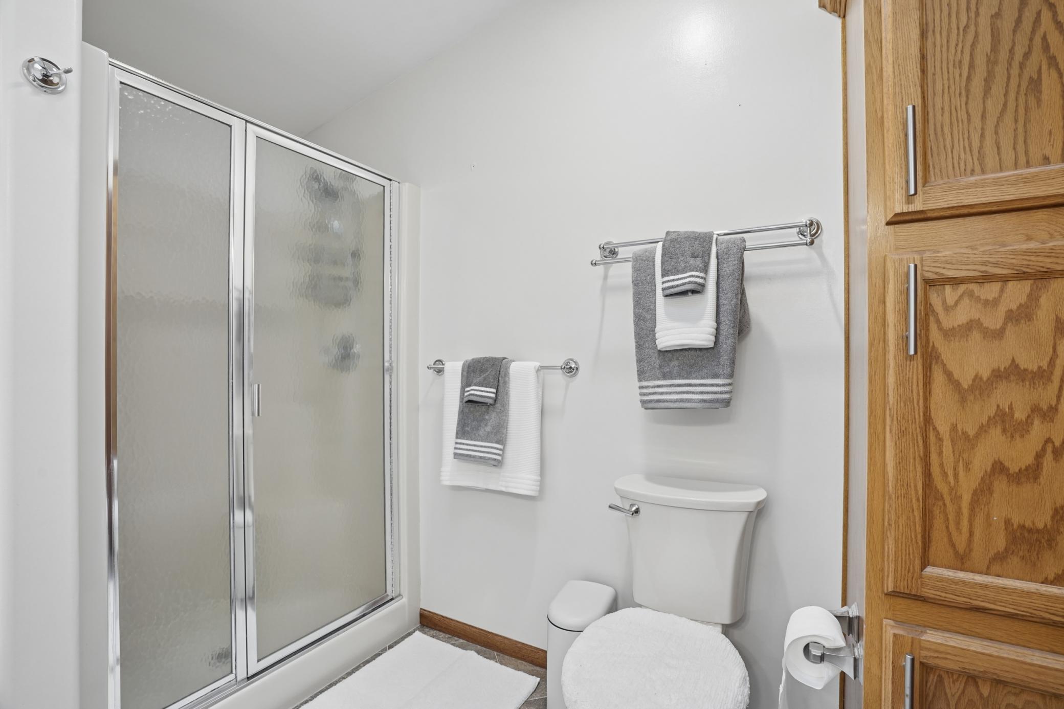 Lots of linen storage is available in the primary ensuite bathroom.