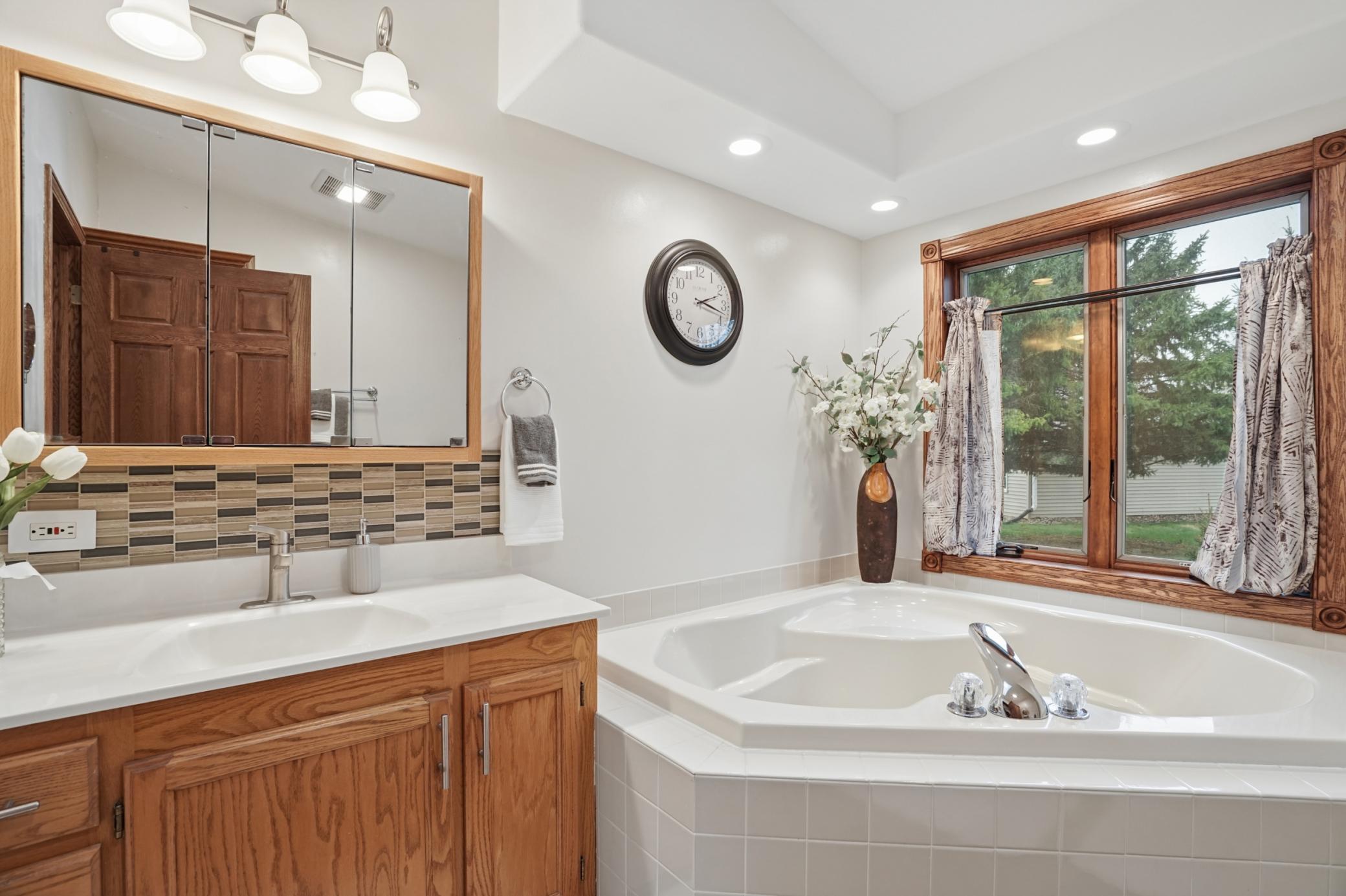 The primary ensuite bathroom features a separate garden tub.
