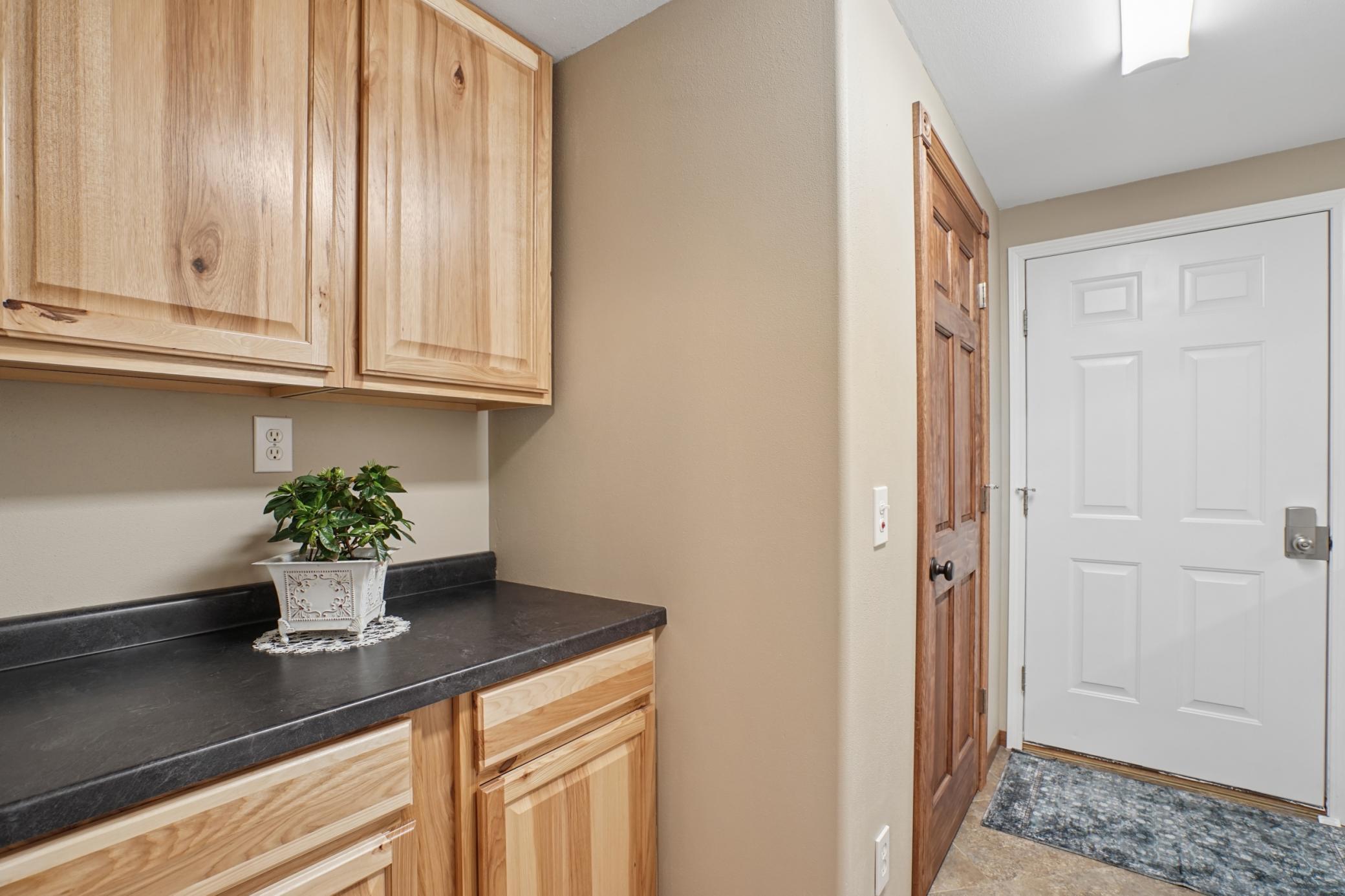 Plenty of storage can be found in the main floor laundry room.