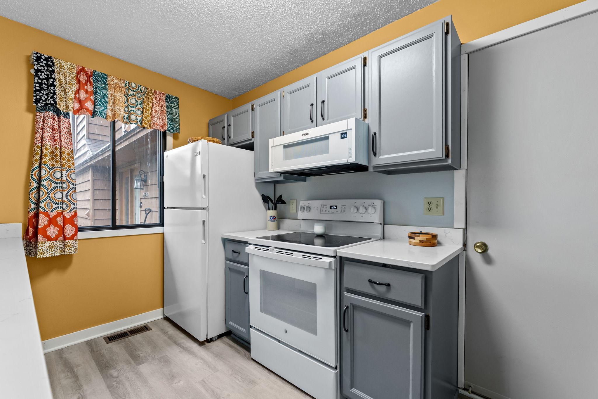 Updated appliances and stylish painted cabinets.