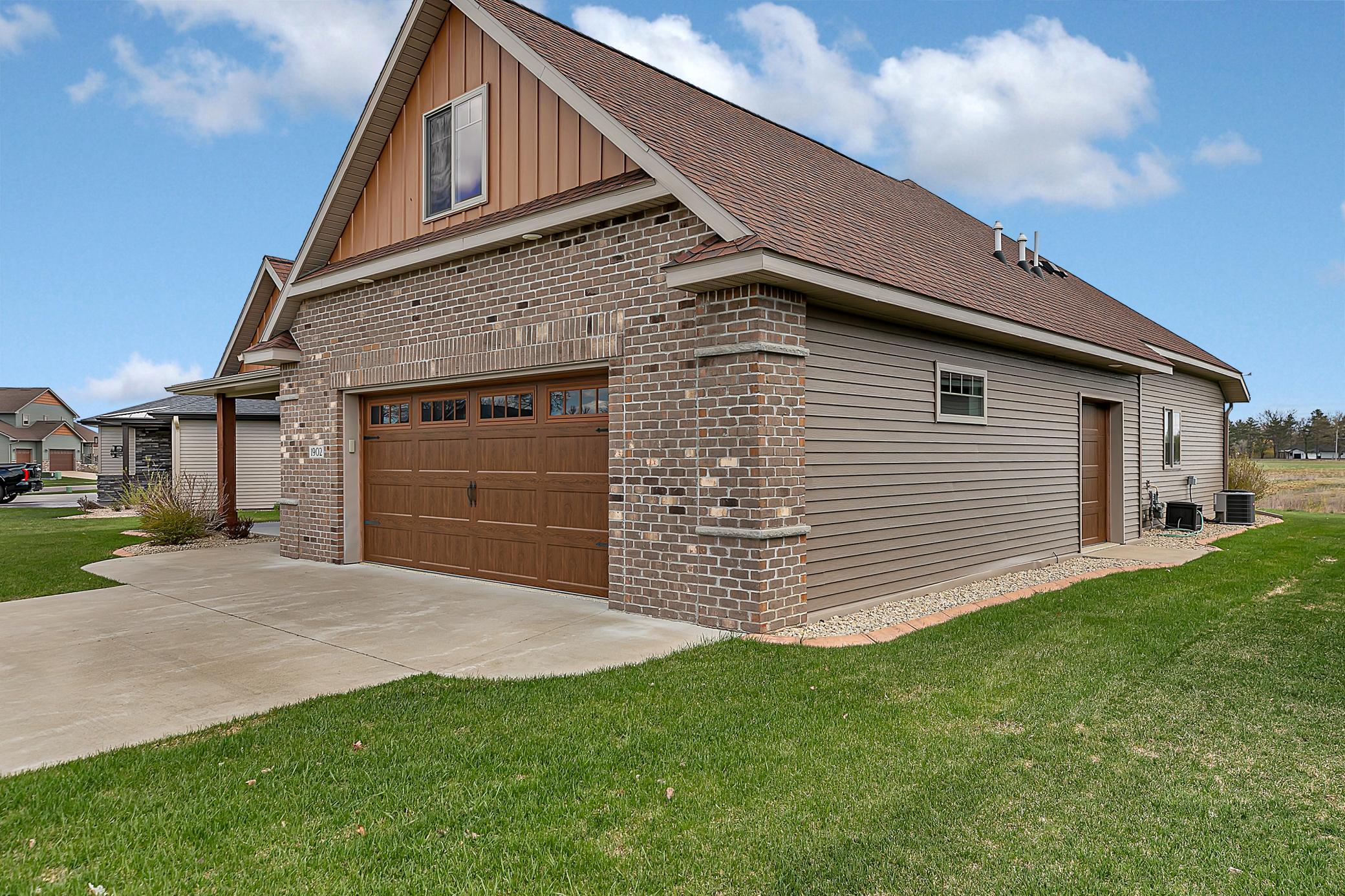 Oversized, fully finished and heated two-stall garage, complete with commercial-grade epoxy floors, a floor drain, and a LiftMaster opener with myQ Wi-Fi capability.