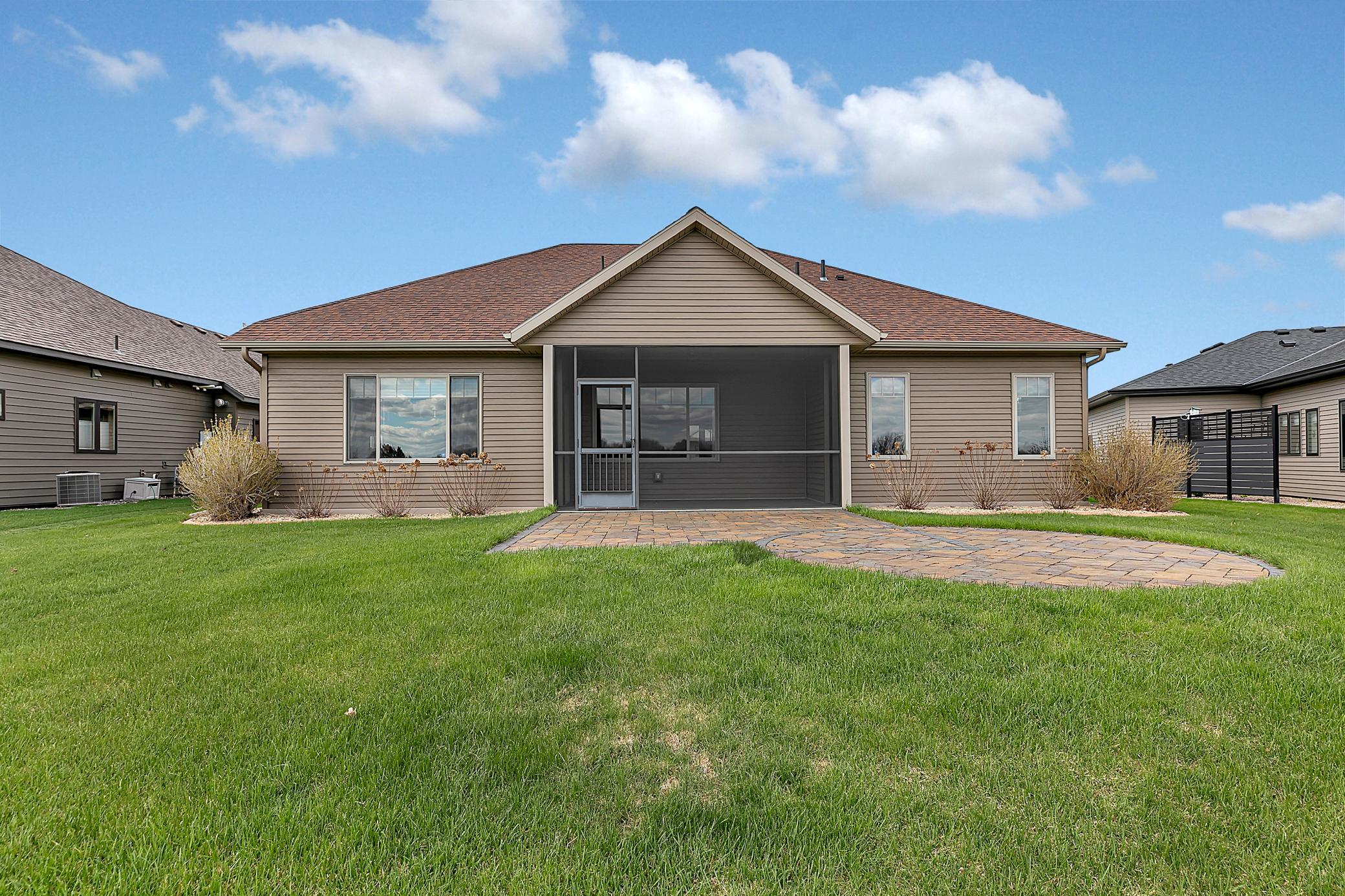 The fully landscaped yard includes poured concrete edging, and peaceful, open views.