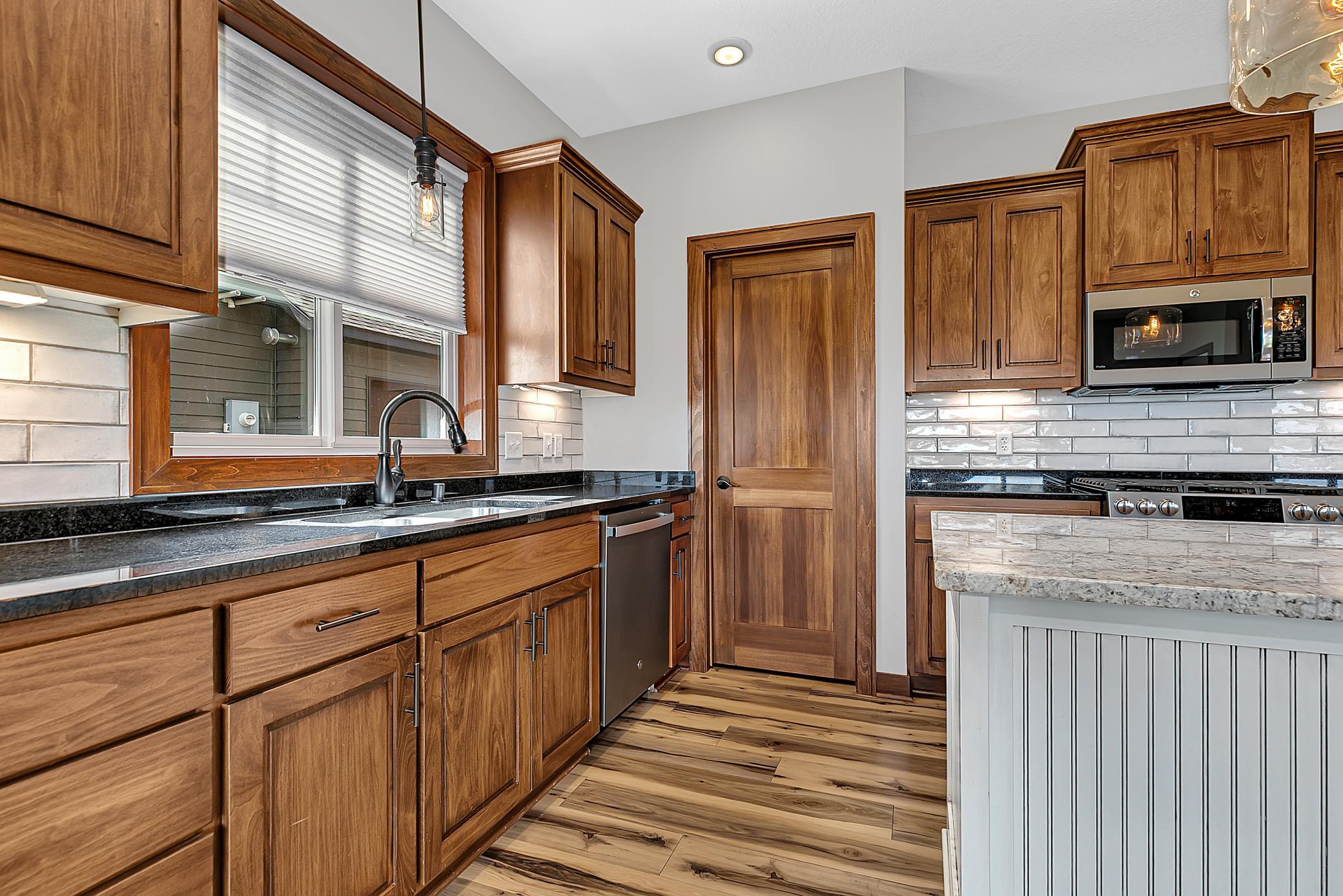 A walk-in pantry with automatic lighting provides extra storage space.