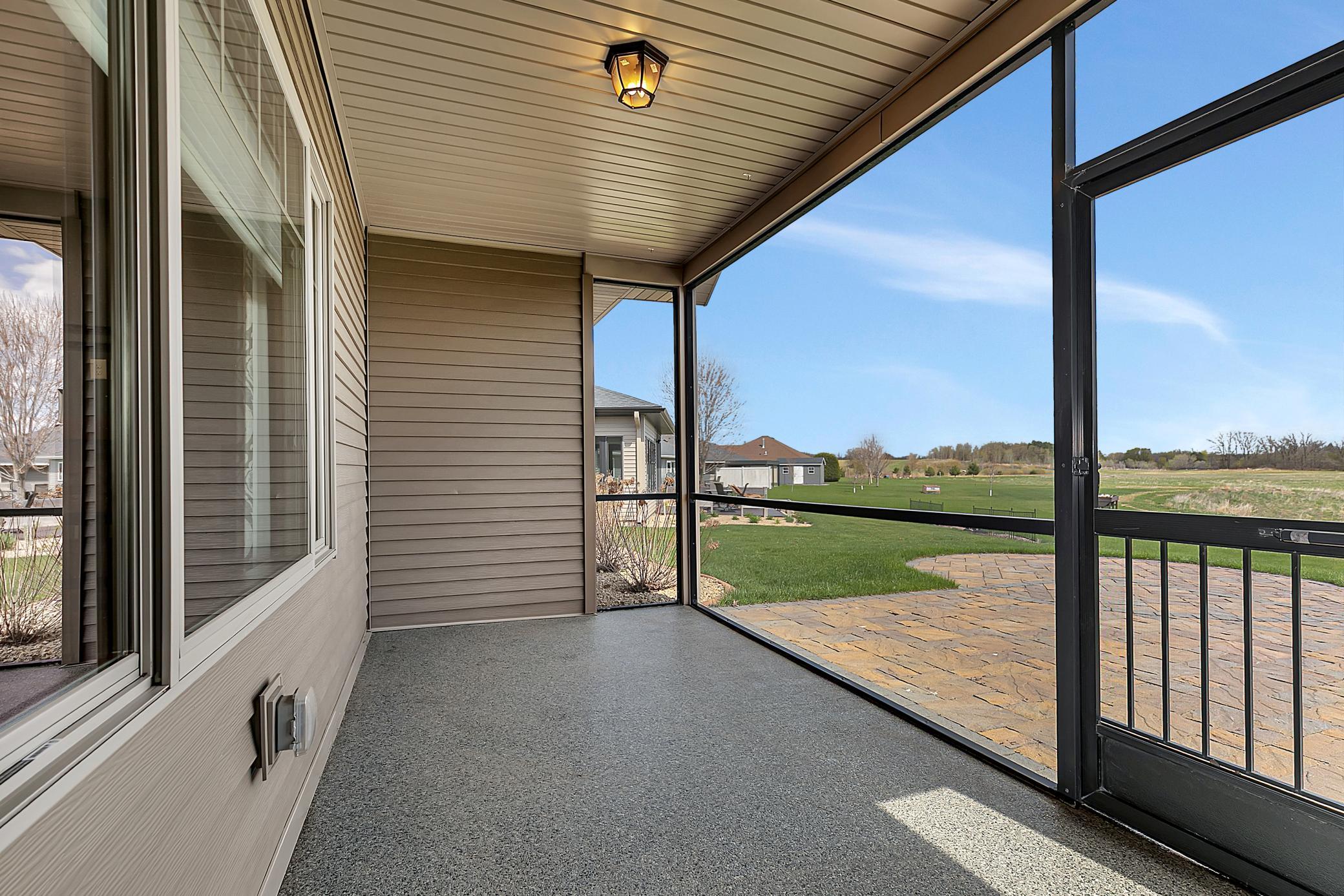 Step into the screened-in rear porch with epoxy flooring.