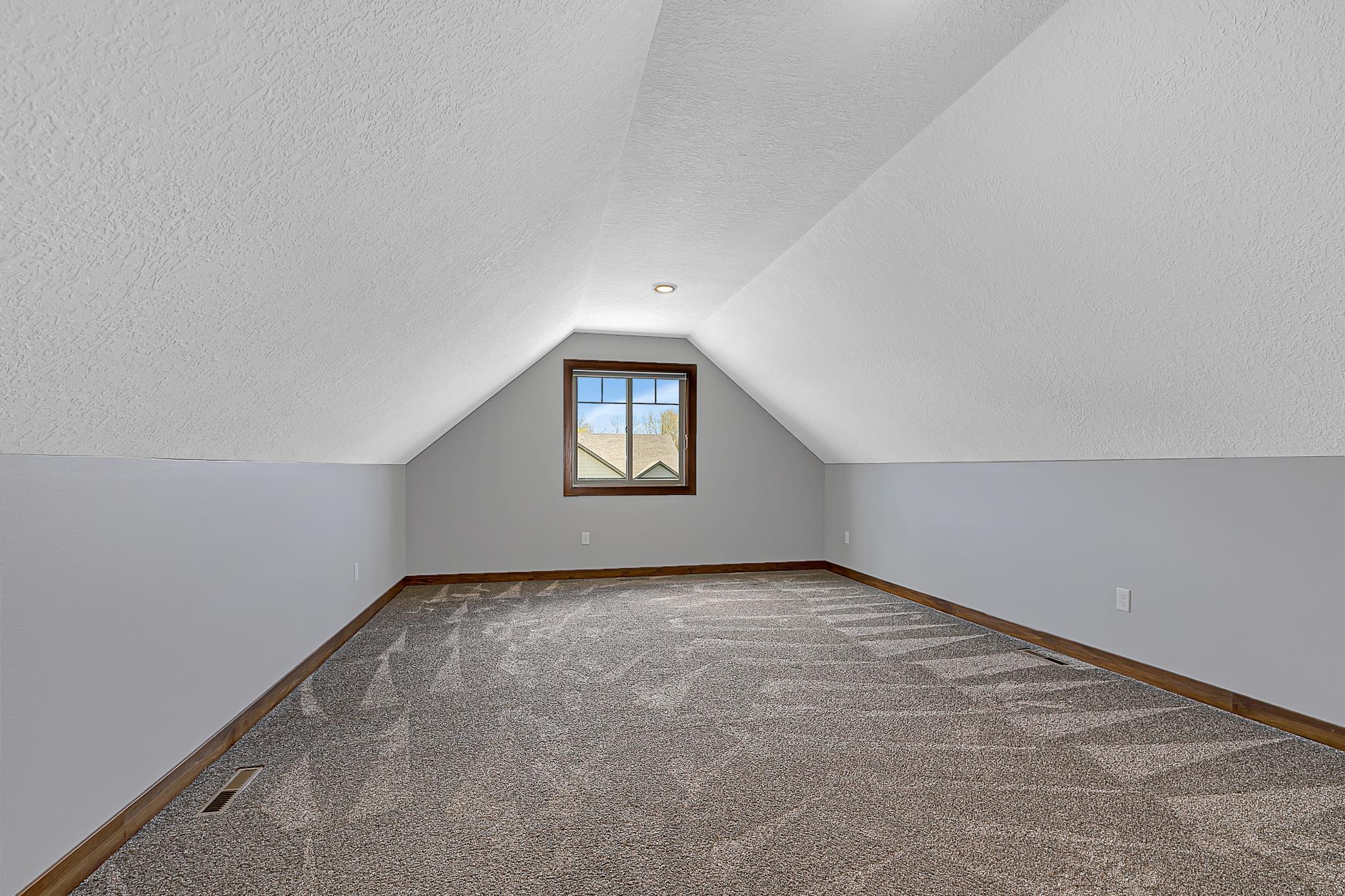 Upper level versatile bonus room—perfect as a fourth bedroom.