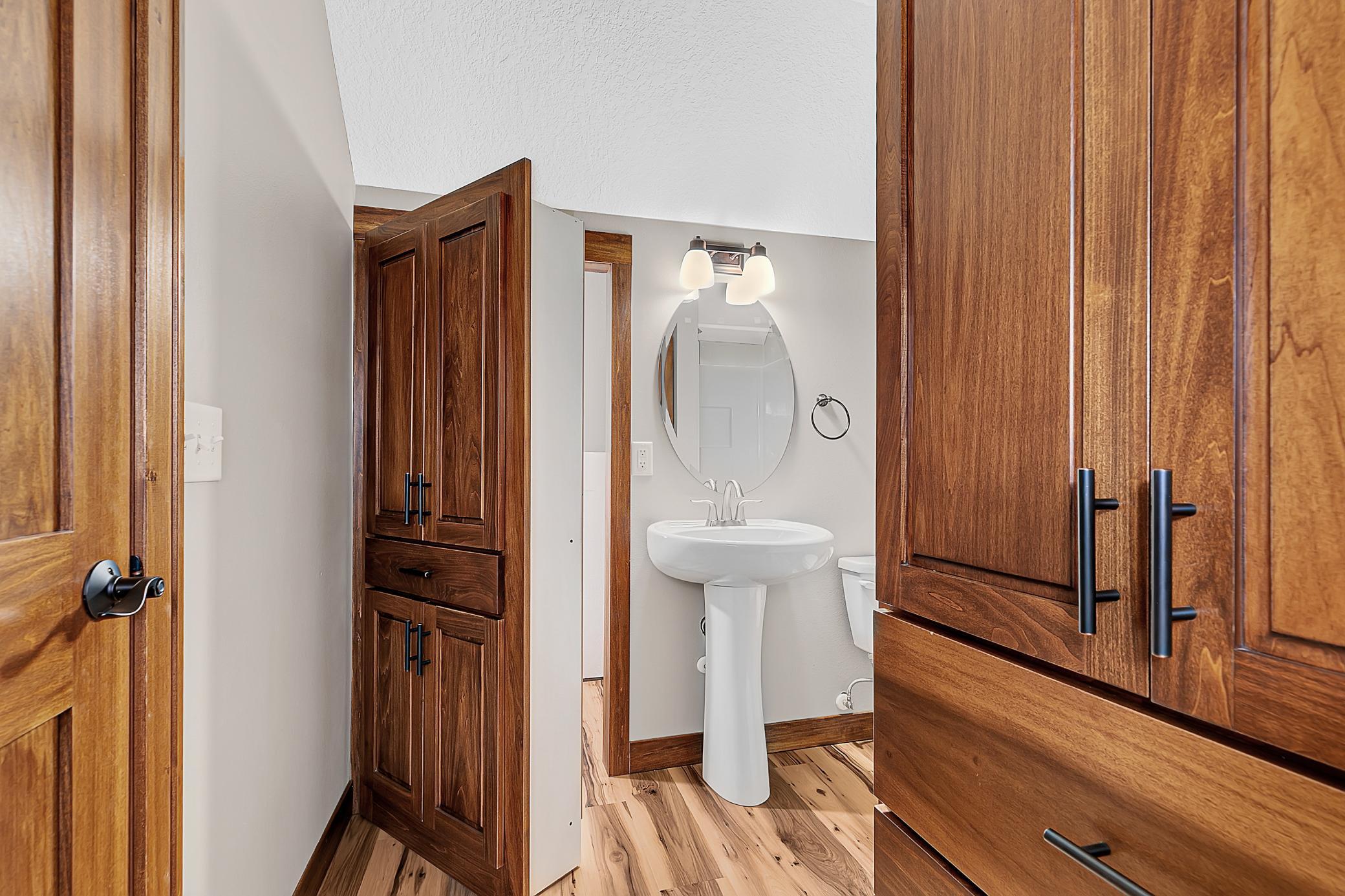 Upper level three-quarter bath with a hidden closet space.
