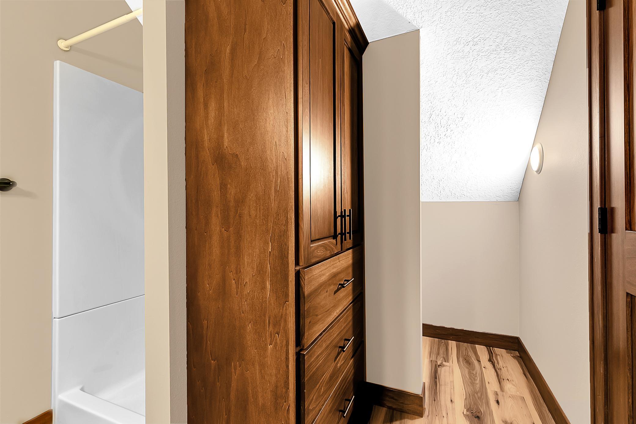 Shower unit and more storage behind it. This upper level offers flexibility for guests or a private retreat.