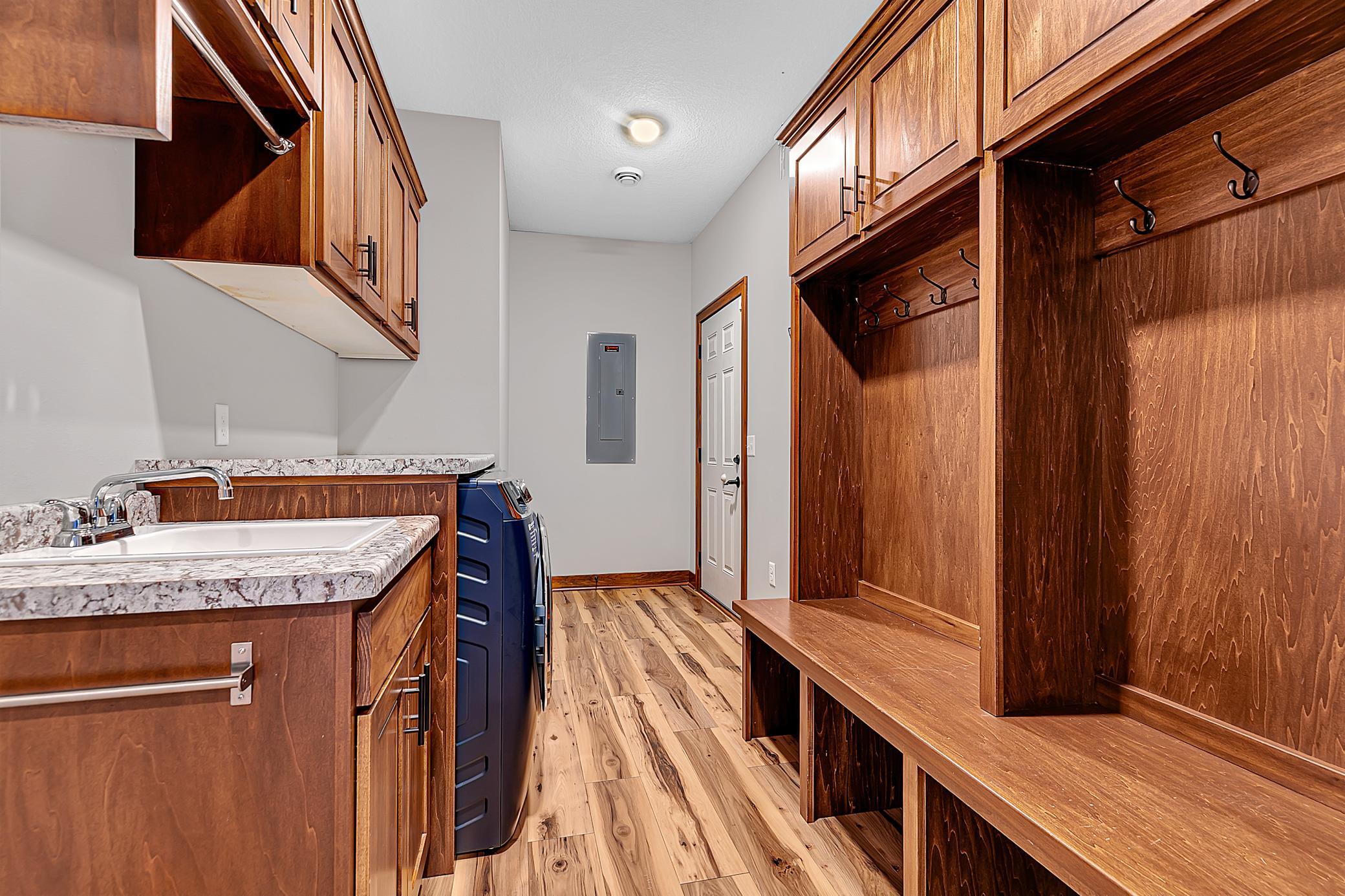 An open locker system will help keep everything organized. A pocket door allows you to tuck this space neatly out of sight when desired.