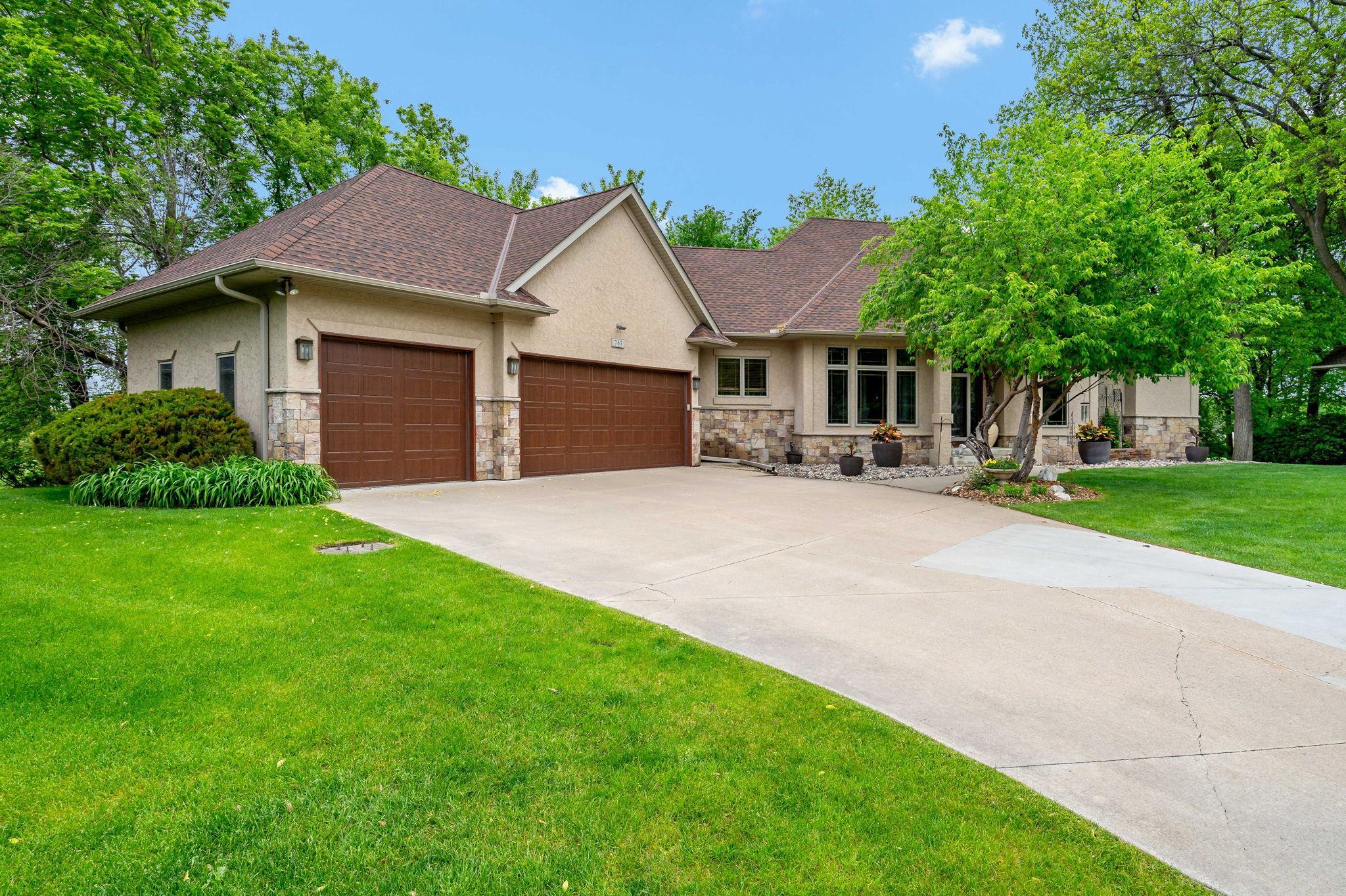 Generous 3 car garage and concrete driveway