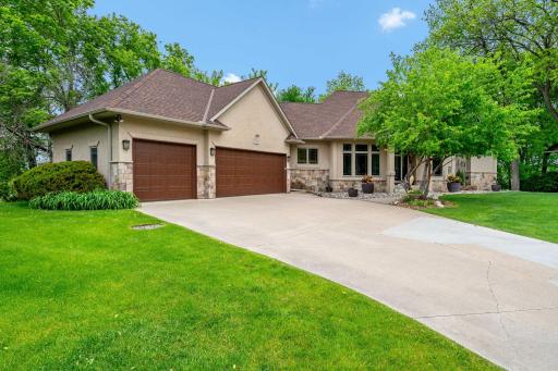 Generous 3 car garage and concrete driveway