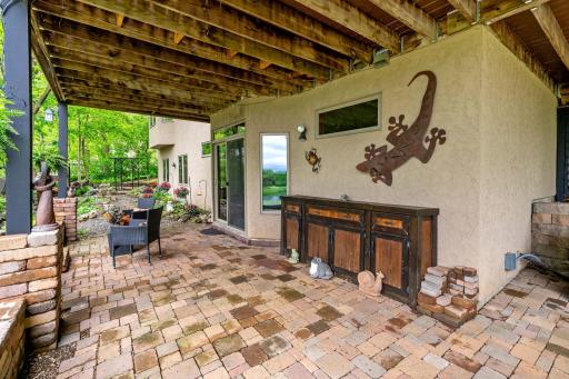 Walkout basement leads to this large paver patio.