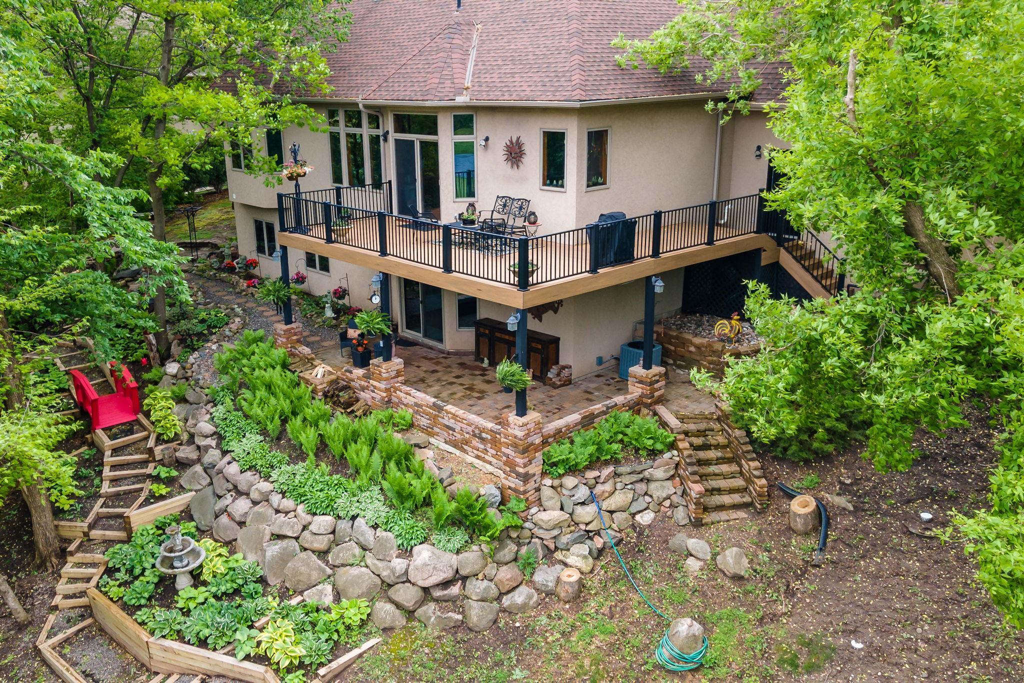 Great picture of the Deck, patio underneath, and perennial gardens.