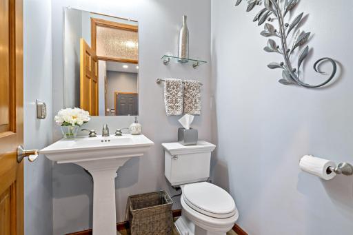1/2 bathroom located for convince off the hallway coming in from the garage.
