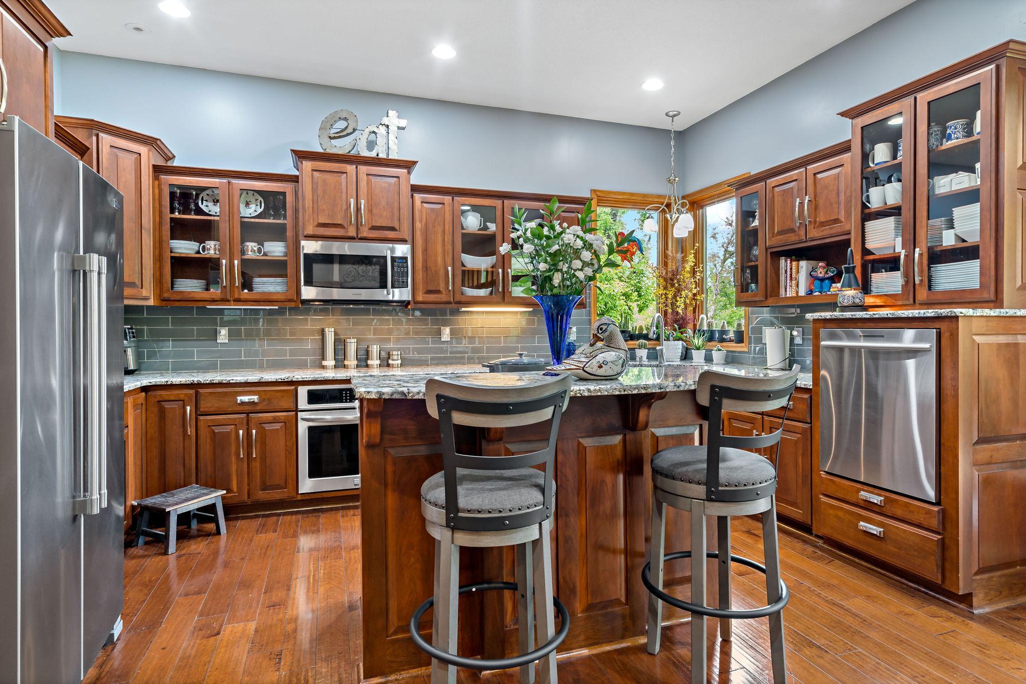 Kitchen island is perfect for conversation. The elevated dishwasher was added for convince of loading and unloading.