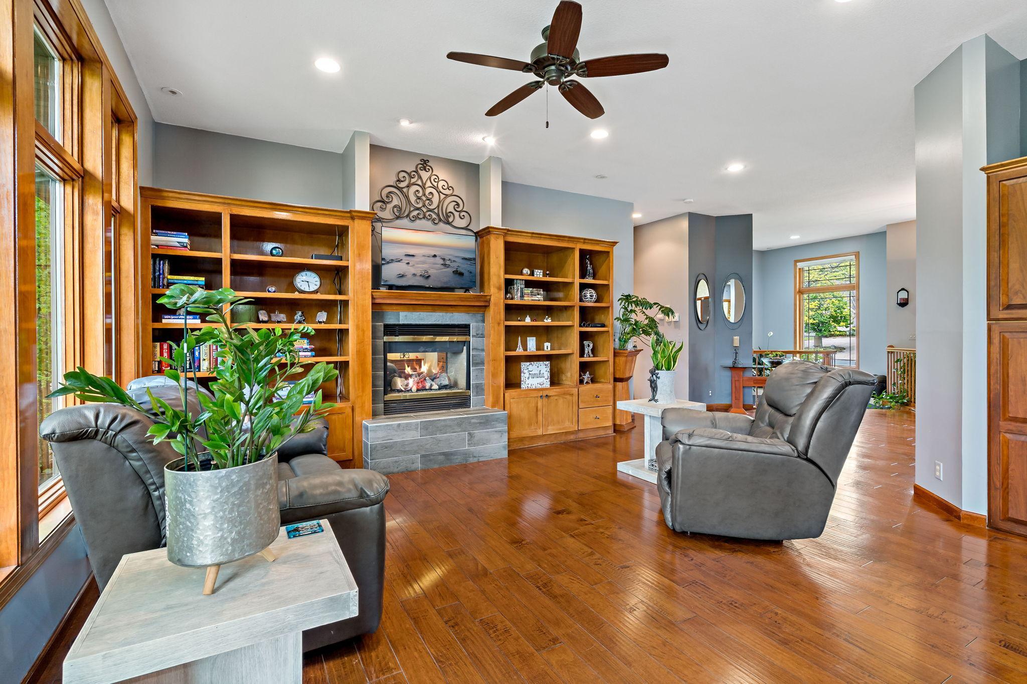 Beautiful custom built-ins surround the gas fireplace.