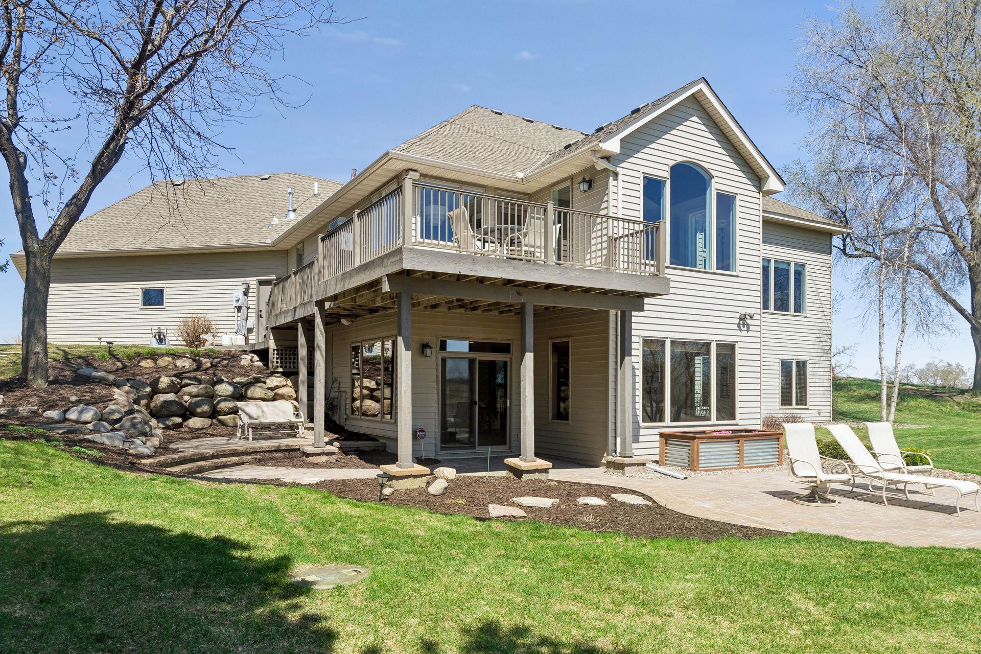 Landscaping includes boulder wall, patios, fresh mulch and perennials