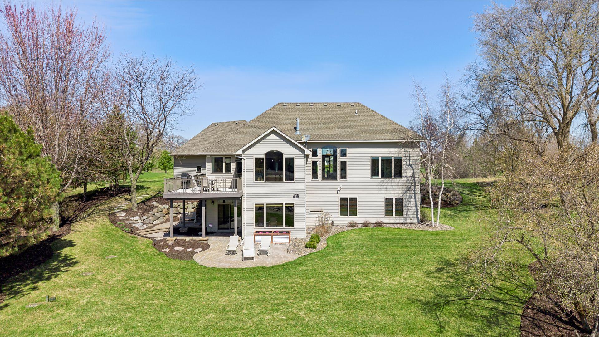Back of the home. Note 2 patios, stunning landscaping.