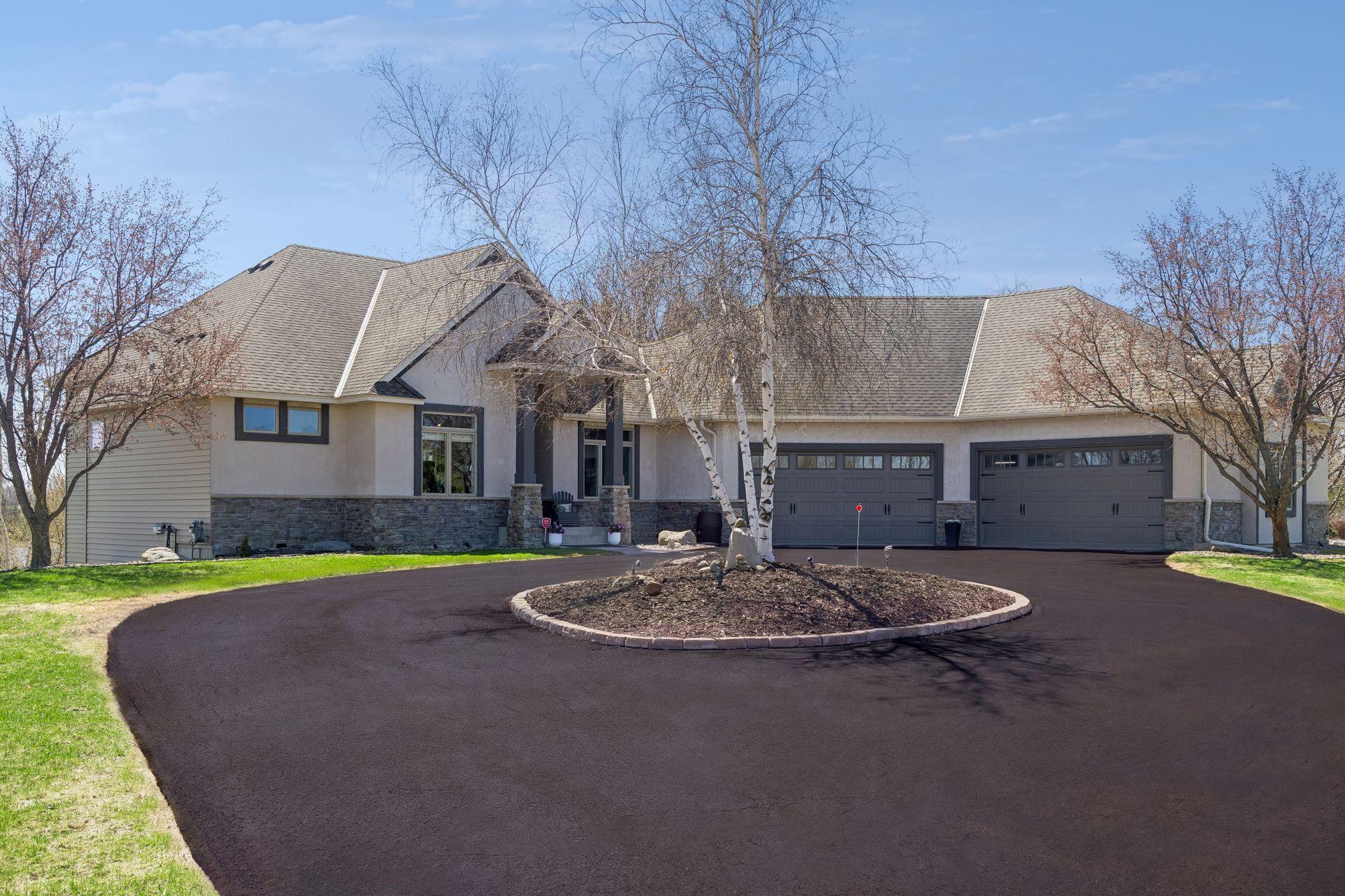 Beautiful circle with birch tree and perennials. Driveway freshly sealed