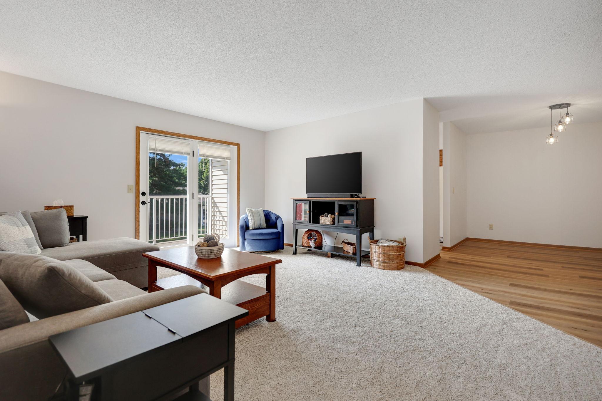 The large living room offers new carpet and walk out to the deck.