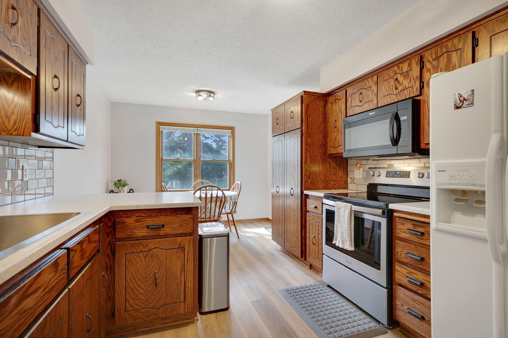 Beautiful new counters, deep stainless steel sink and Refiinished cabinets. The end cabinet pantry with pull out shelves.