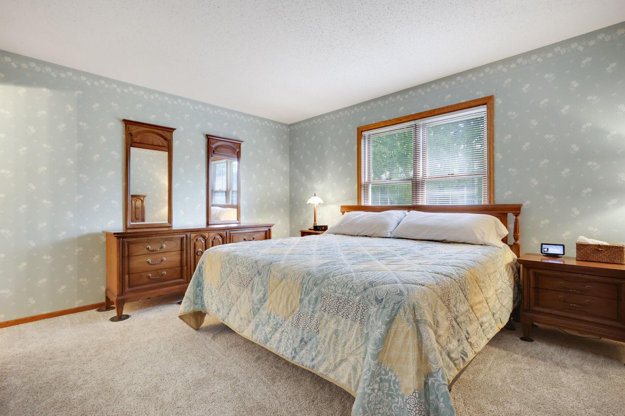 Spacious primary bedroom offers walk in closet and private 3/4 bathroom.