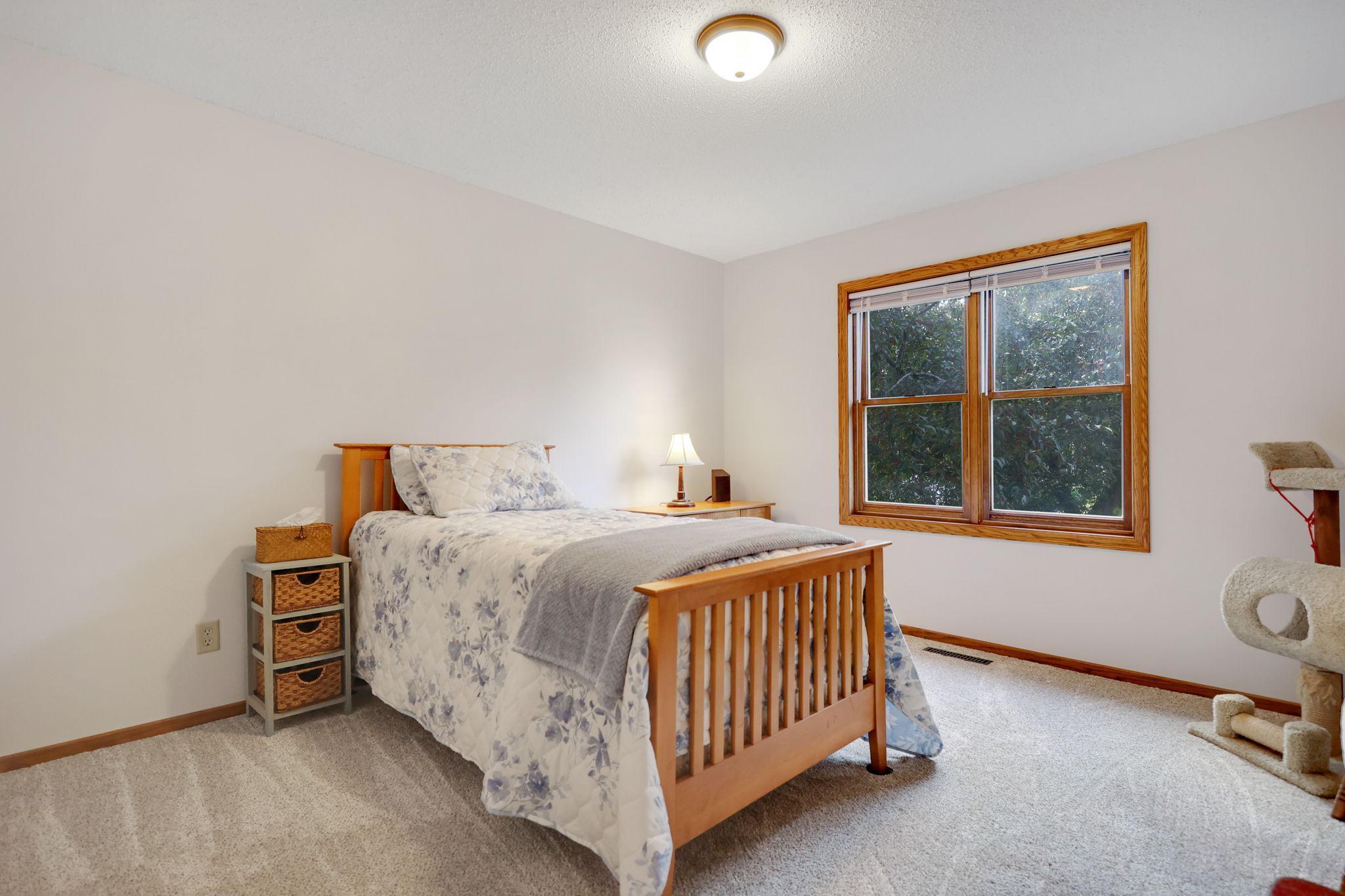 Quest bedroom features new carpet and great views of the yard.